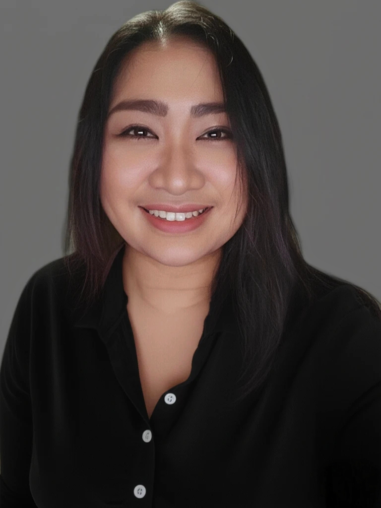 A woman with long dark hair smiling, wearing a black button-up shirt, against a plain gray background.