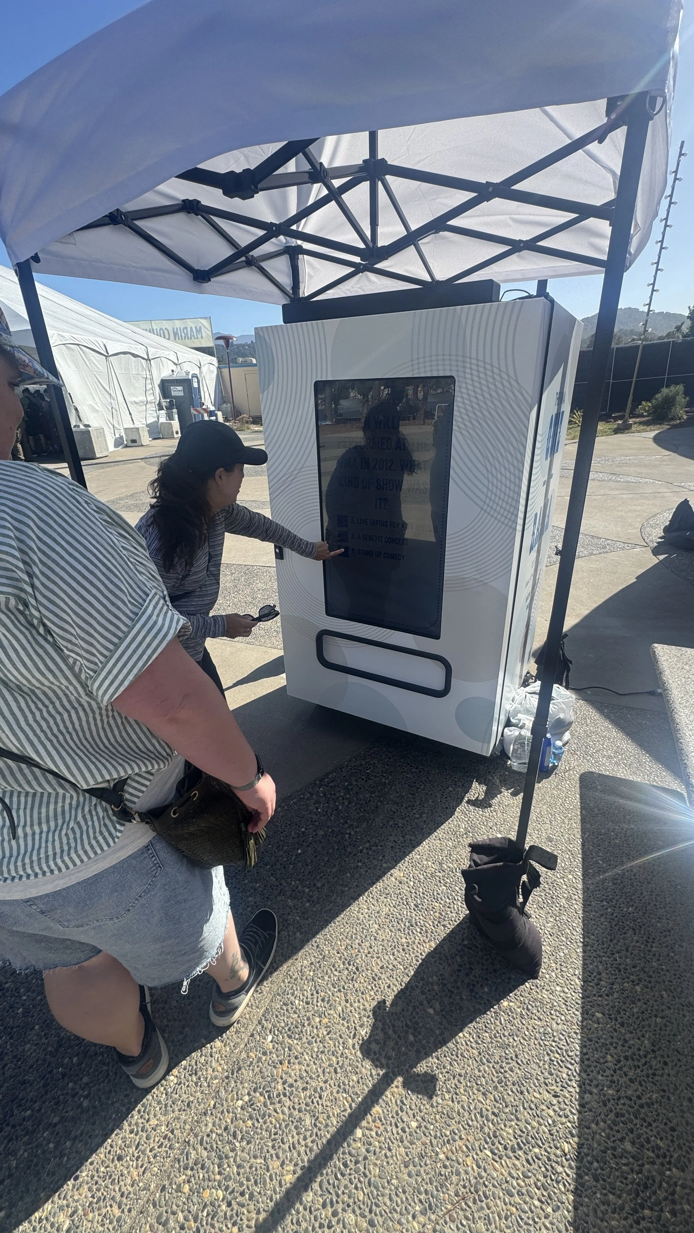People using a social media vending machine in a company event