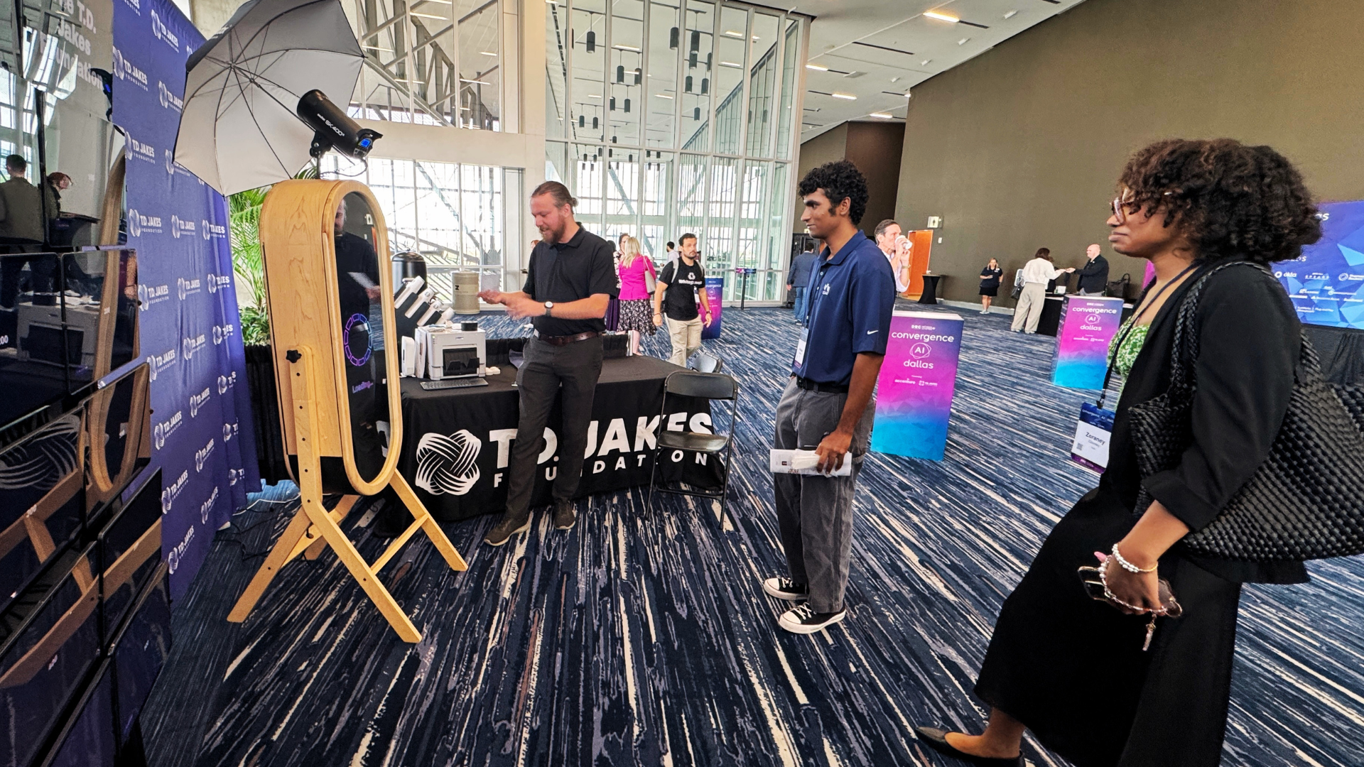 Attendees waiting to try the AI photo booth at a trade show booth