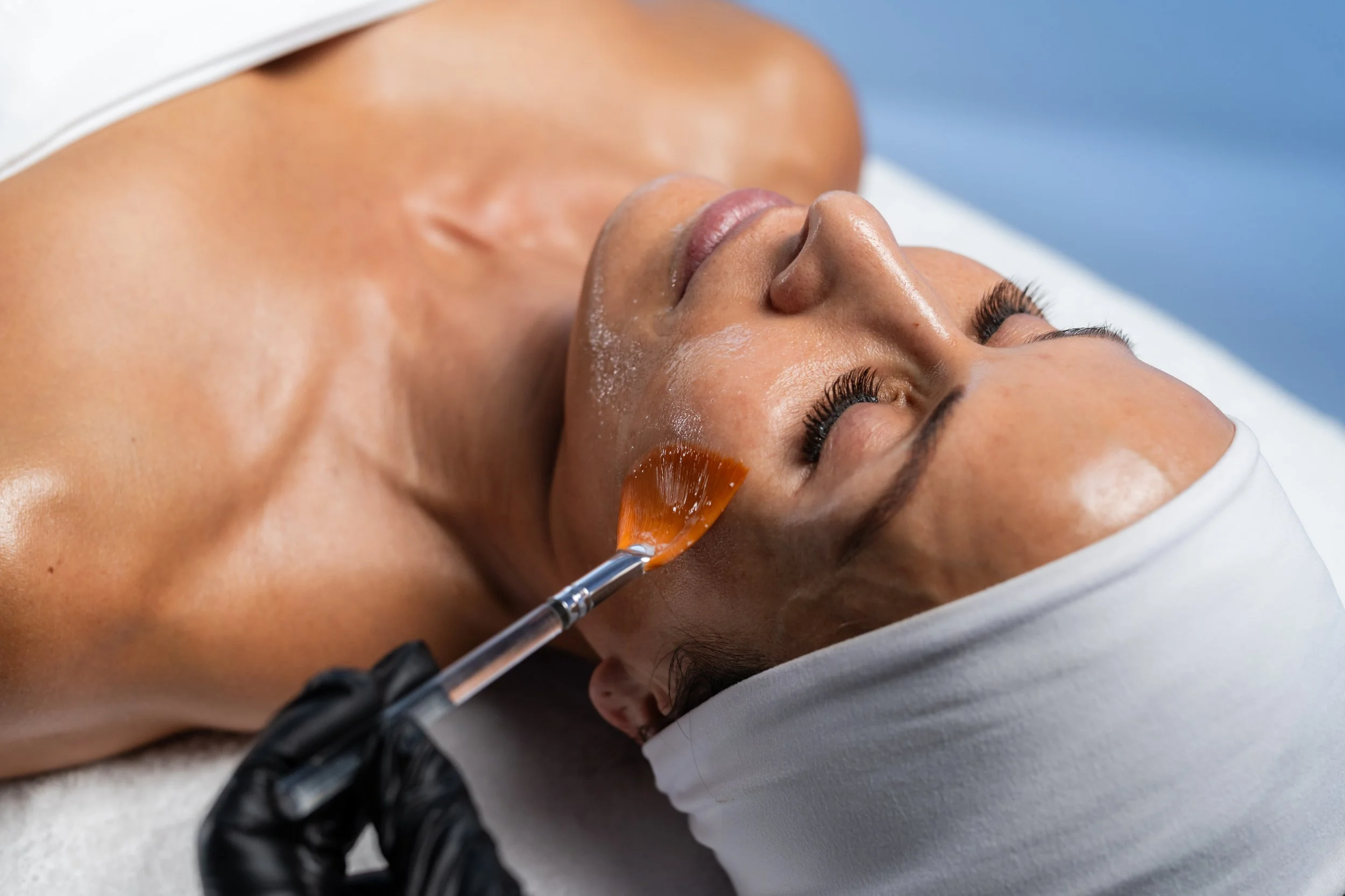 Person getting a facial applied with fan brush