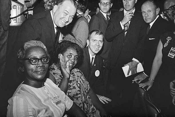 (seated left to right) Annie Devine, Fannie Lou Hamer and Rev. Edwin King, co-founders of the Mississippi Freedom Democratic Party (MFDP), are seated with the Michigan Delegation at the 1964 Democratic Convention.