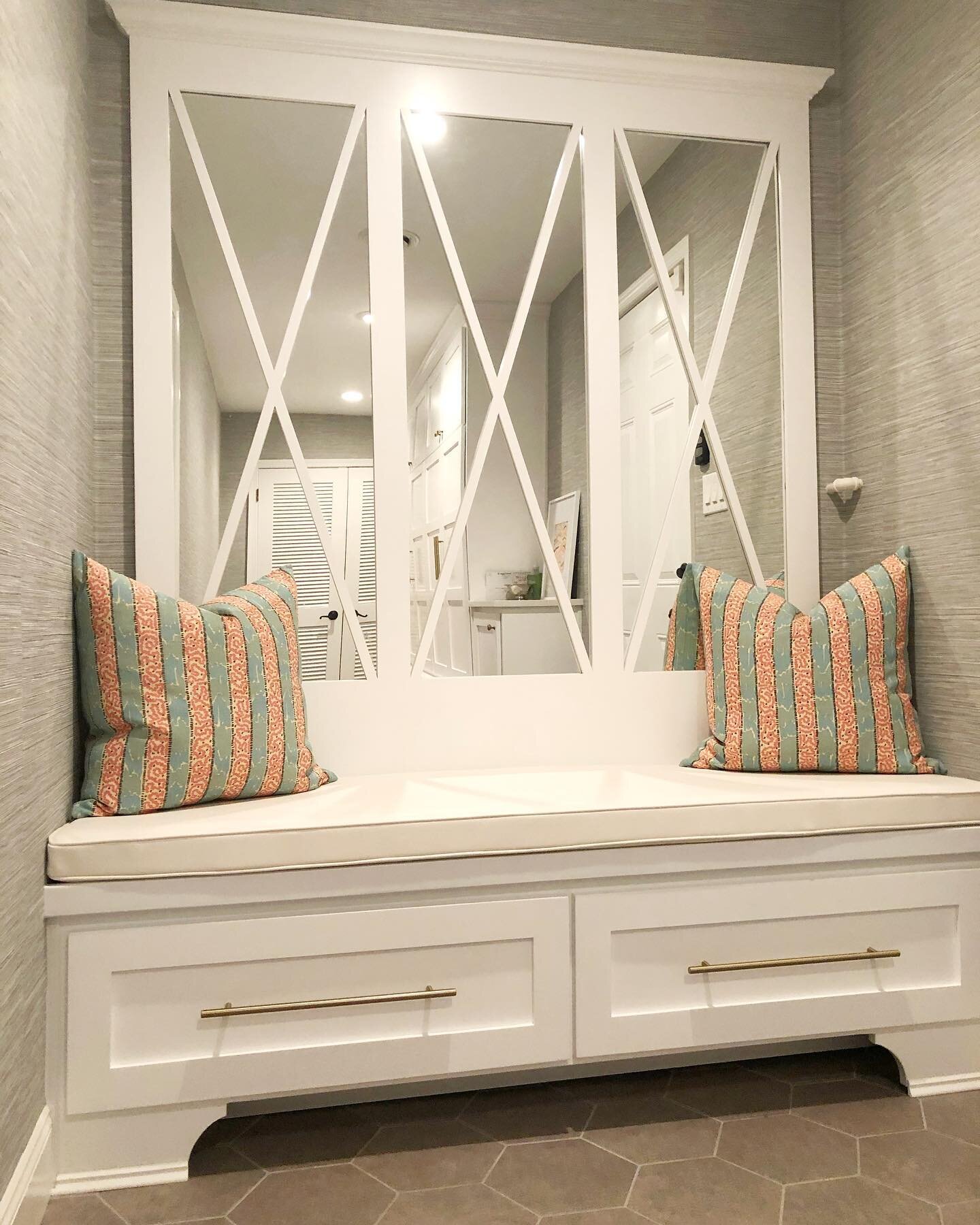 How do you make your mudroom pretty when you know it&rsquo;s going to take a beating? We used a performance vinyl on the bench and walls. We used a vinyl grasscloth by @thibaut_1886 and then dressed it up with some fun pillows by @quadrillefabrics. #