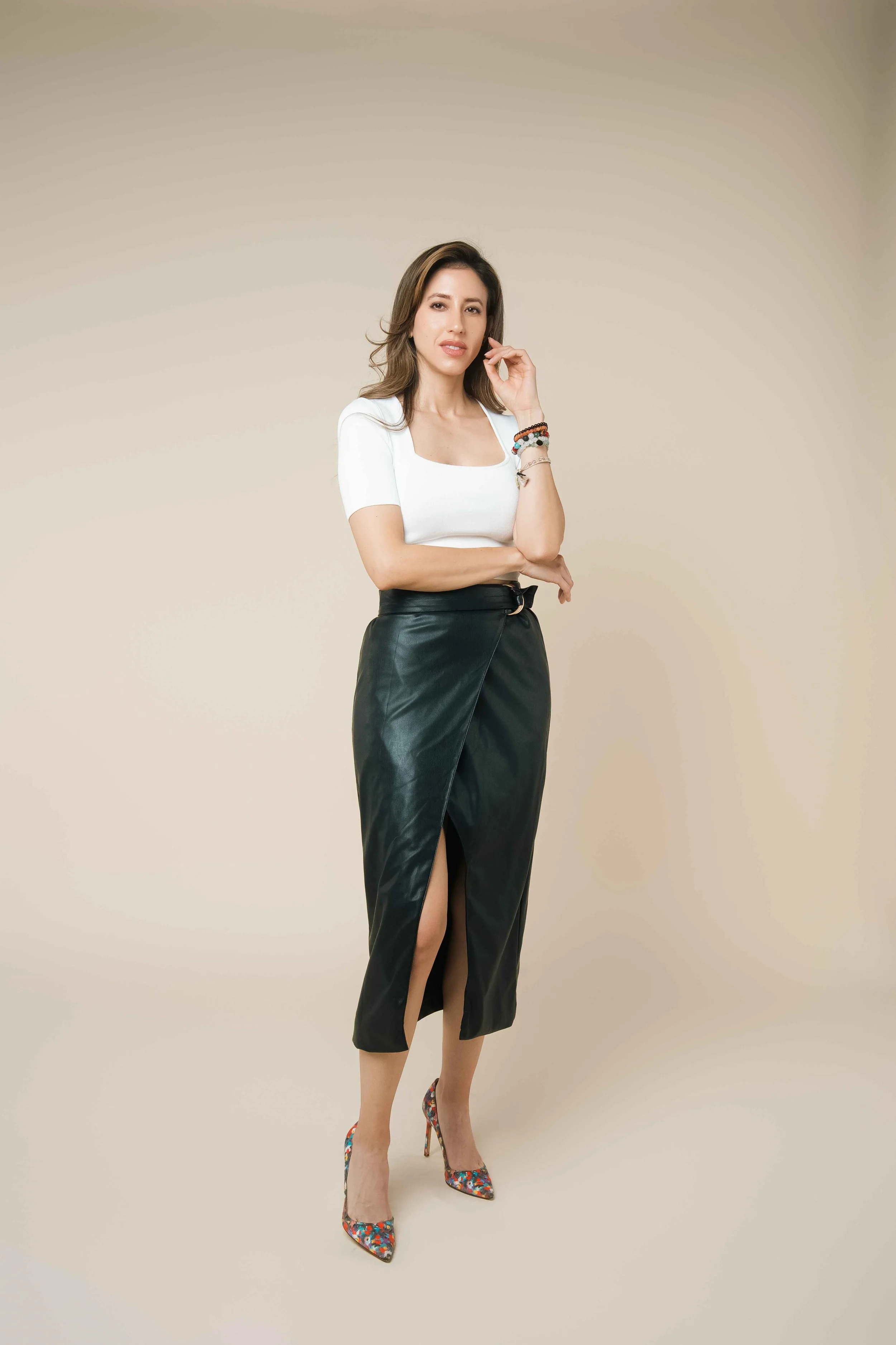 Vanessa Santos, founder and media entrepreneur, in an emerald green suit in a modern lounge setting