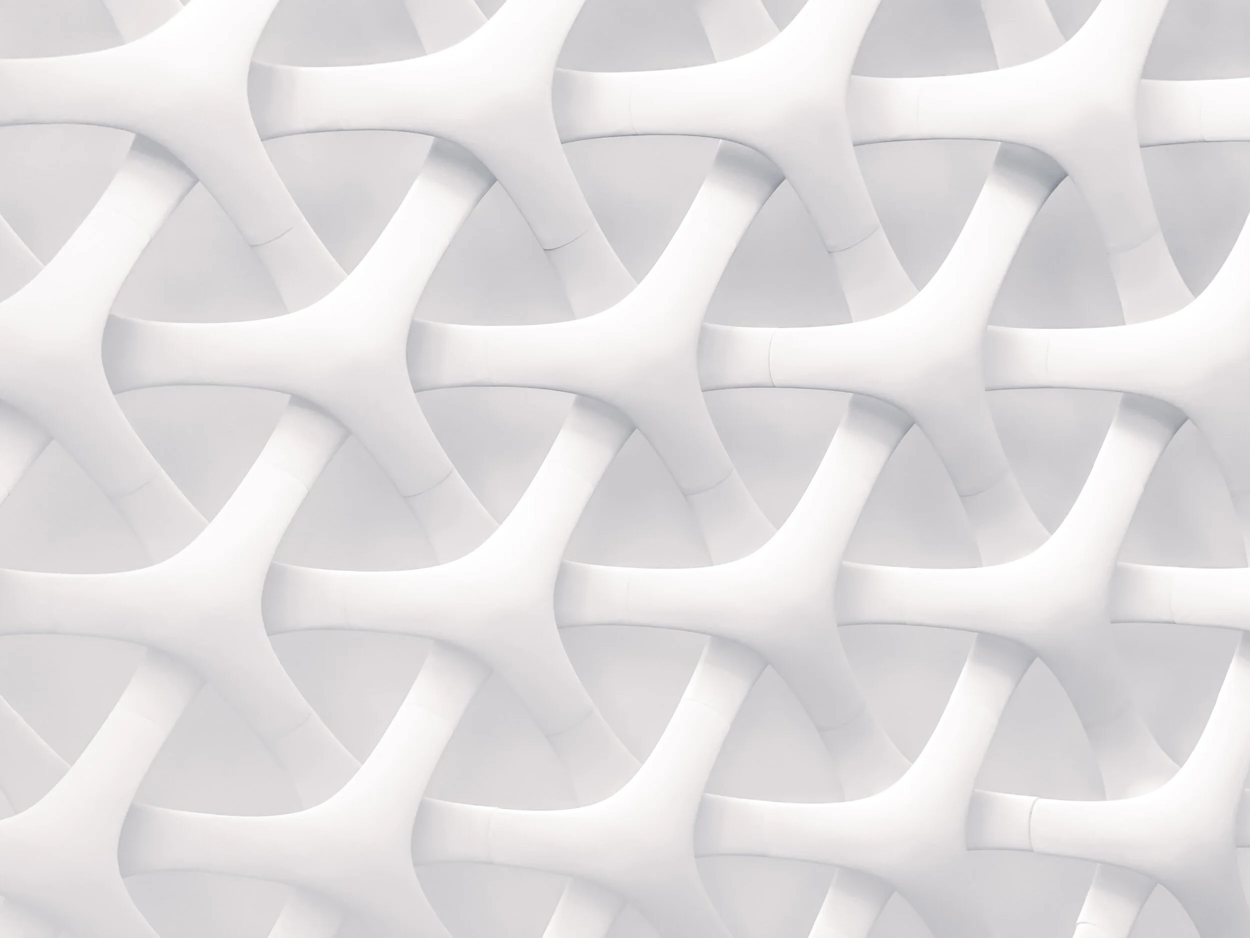 Abstract 3D white geometric pattern with interlocking shapes.