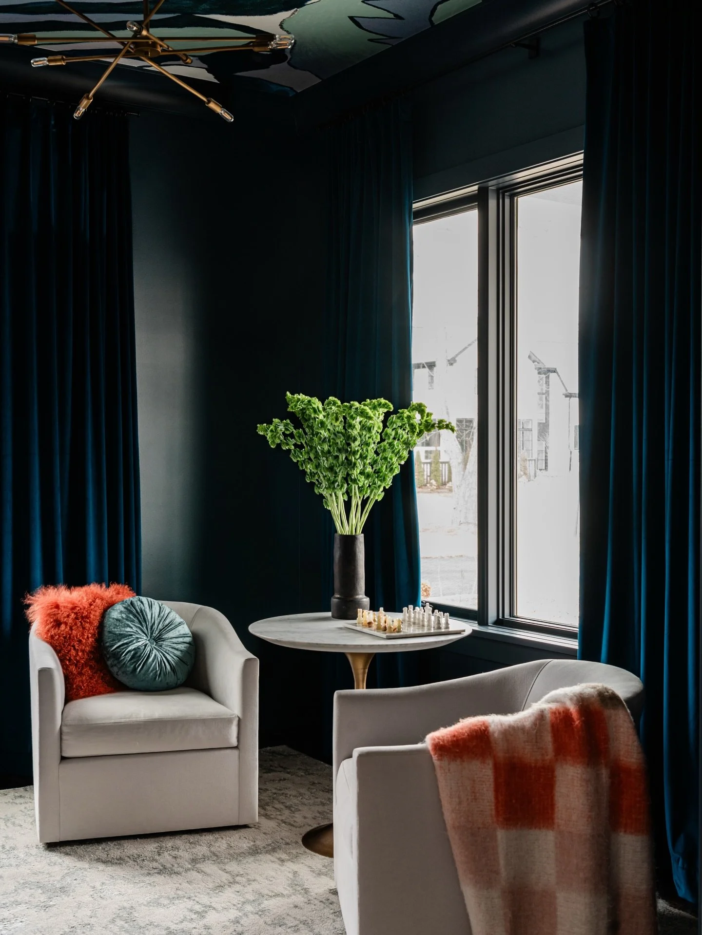 When deep blue becomes the main character, the entire home transforms.

Layered textures &mdash; velvet drapery, warm wood, matte cabinetry, brushed brass &mdash; add dimension and tactile richness. Soft sculptural seating balances the architectural 