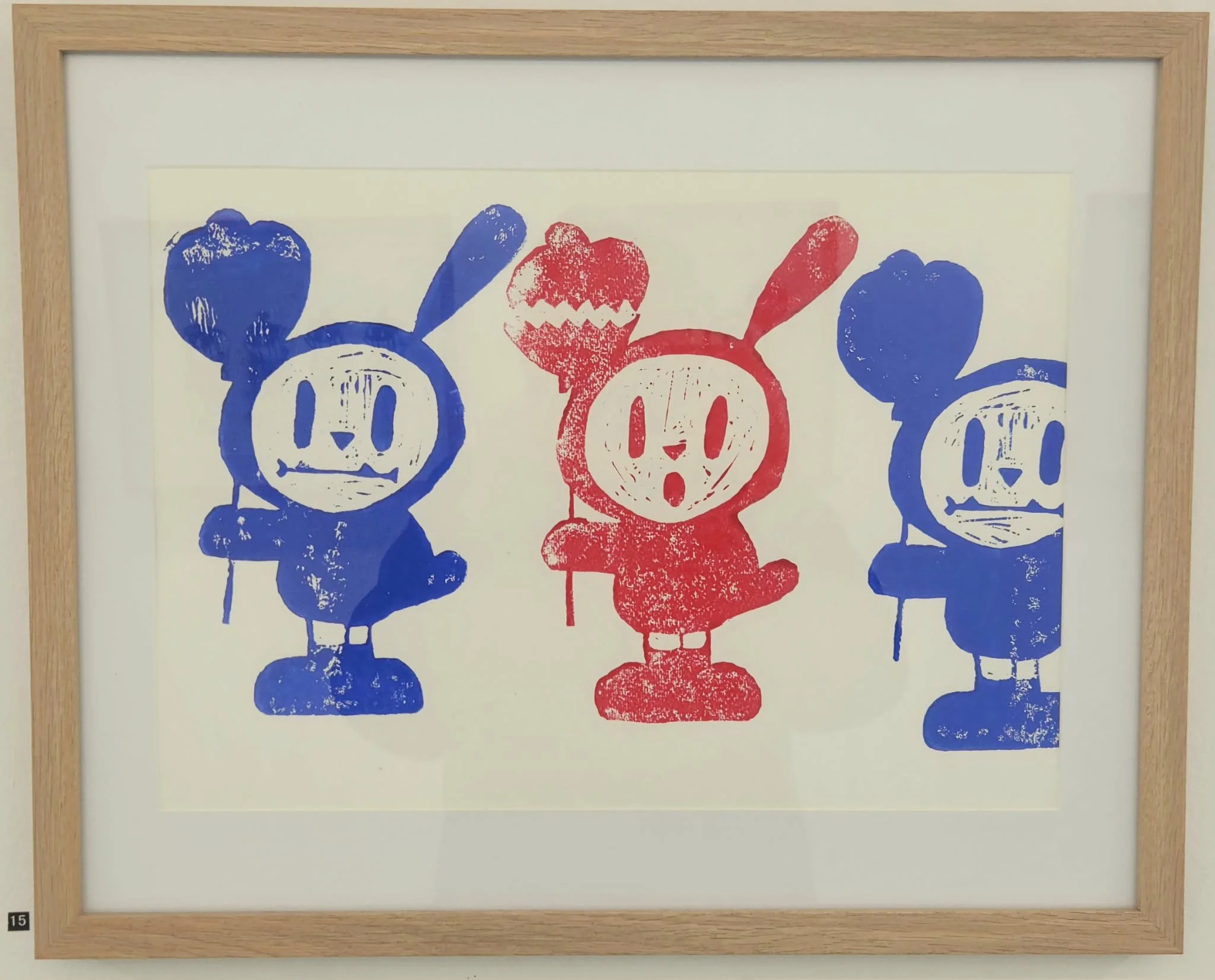 Framed blue bunny and red bunny lino print