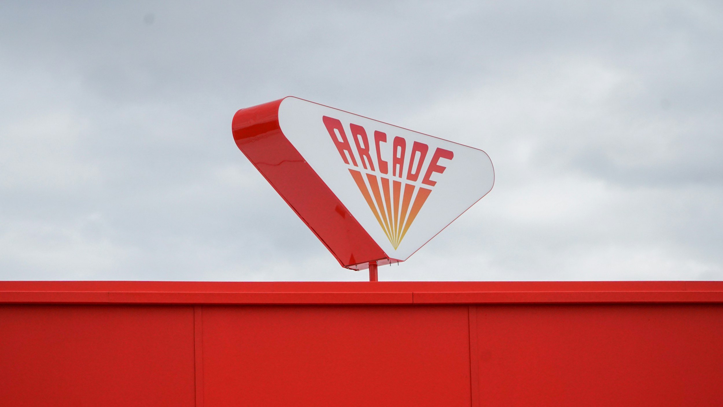 Retro "ARCADE" sign on building.