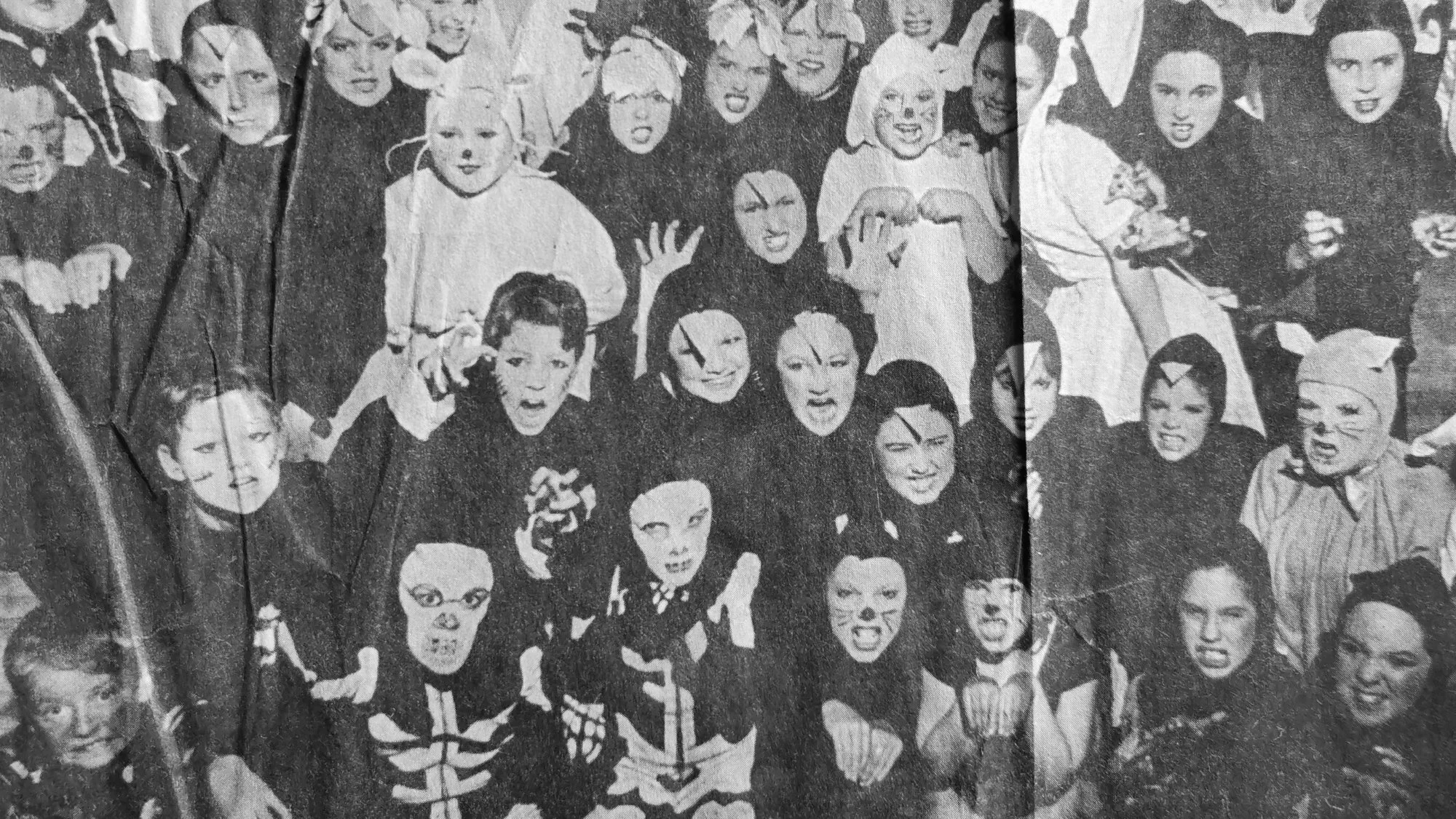 Black and white image of children in zombie and animal costumes, posing with playful and scary expressions from the theatrical performance of "Bad Jelly The Witch".