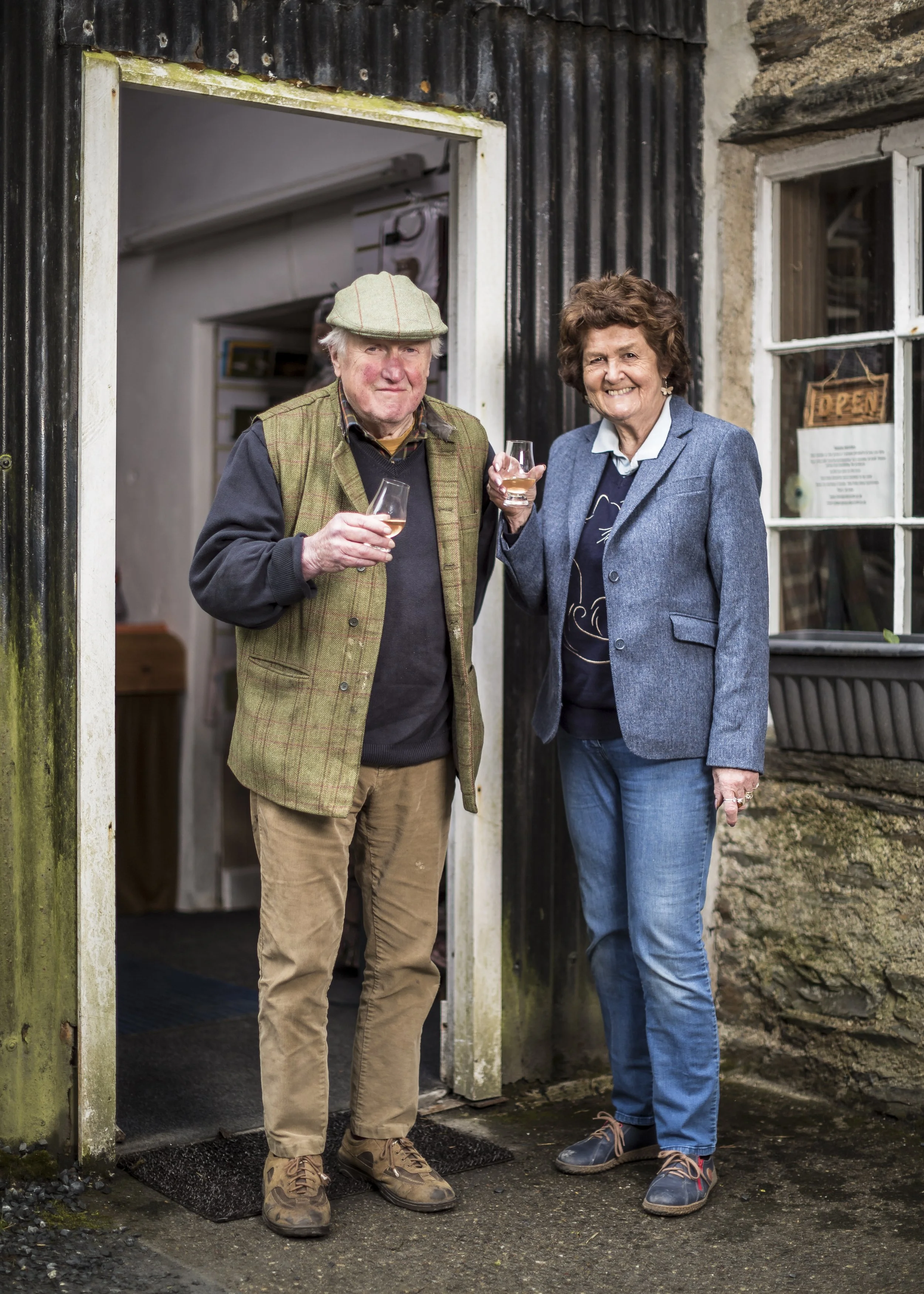 Owners of Islay Woolen Mill with drams of Mac-Talla Terra