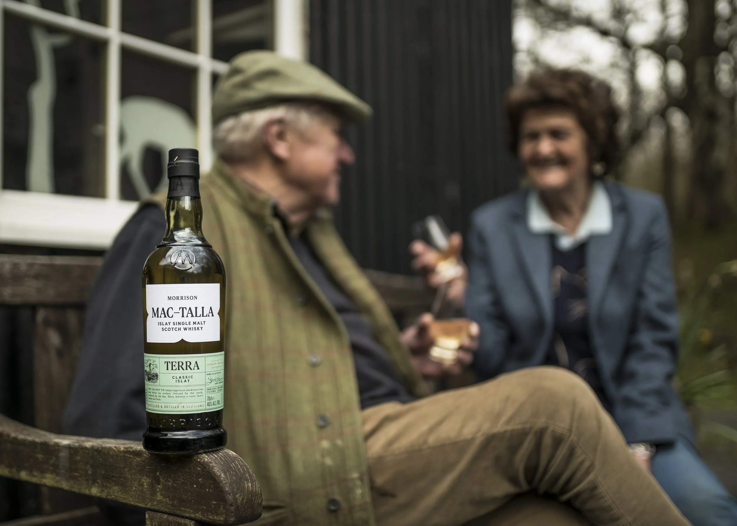 Owners of Islay Woolen Mill with drams of Mac-Talla Terra