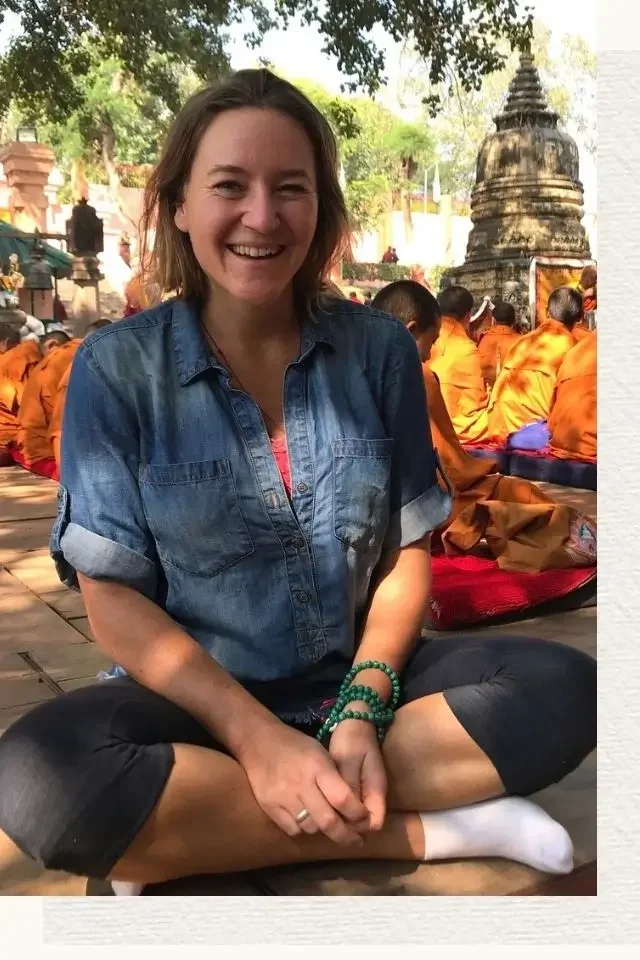 Karin Peeters surrounded by monks at Mahabodhi Temple Bodhgaya India