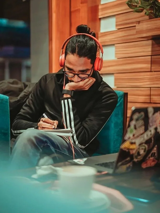 Man reading book and journaling