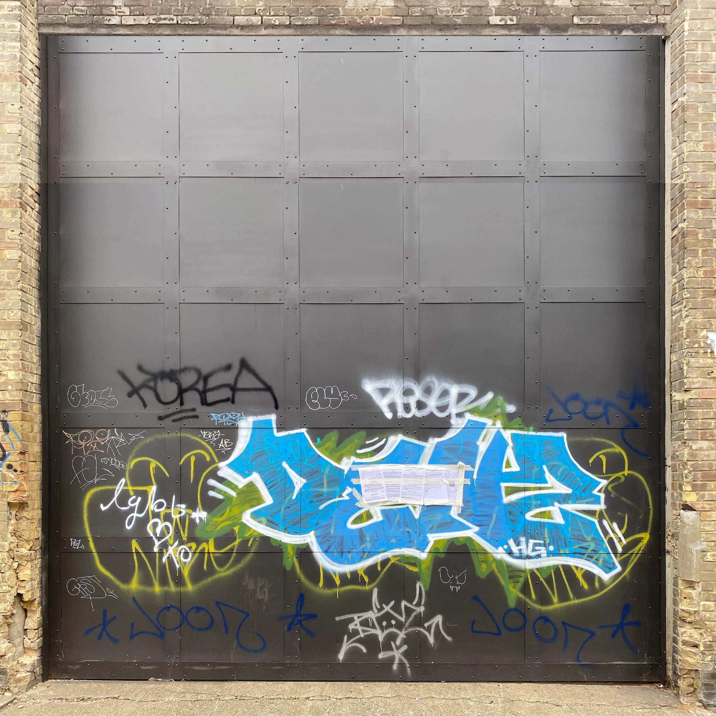 Incongruous? Sliding warehouse door in sheet steel with solid riveted, Victorian industrial design references. c.2005