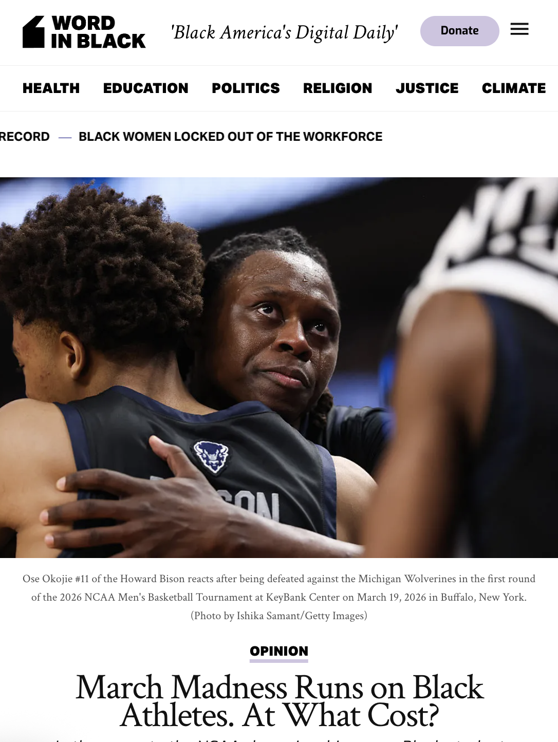 Black woman athlete being comforted by woman with hairstyle in a sports arena after a game, wearing a black athletic jersey.