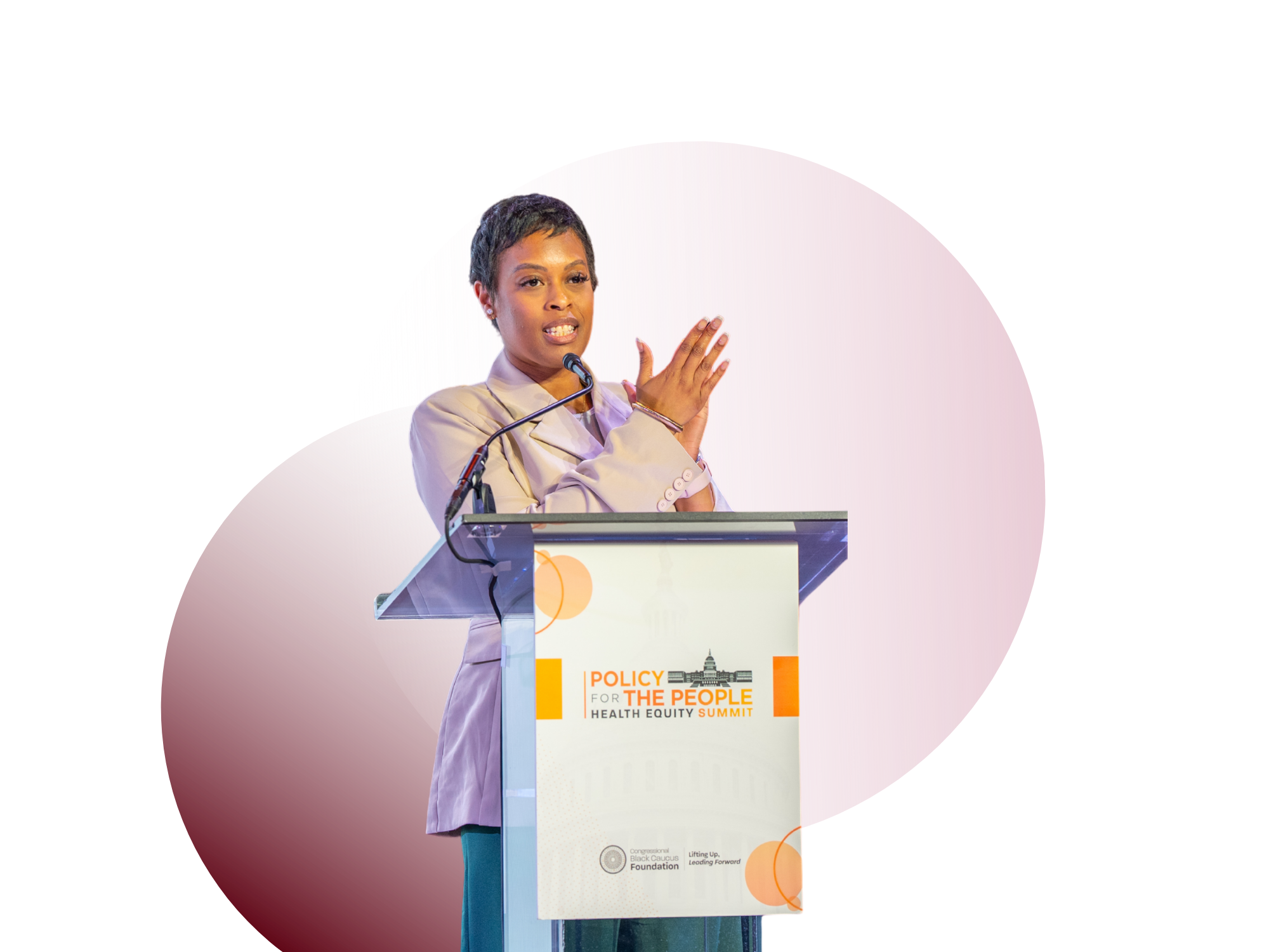 Dr. Ashley M. Stewart speaking at a podium during the Policy for the People Health Equity Summit, with a banner that reads "Lifting Up, Leading Forward."