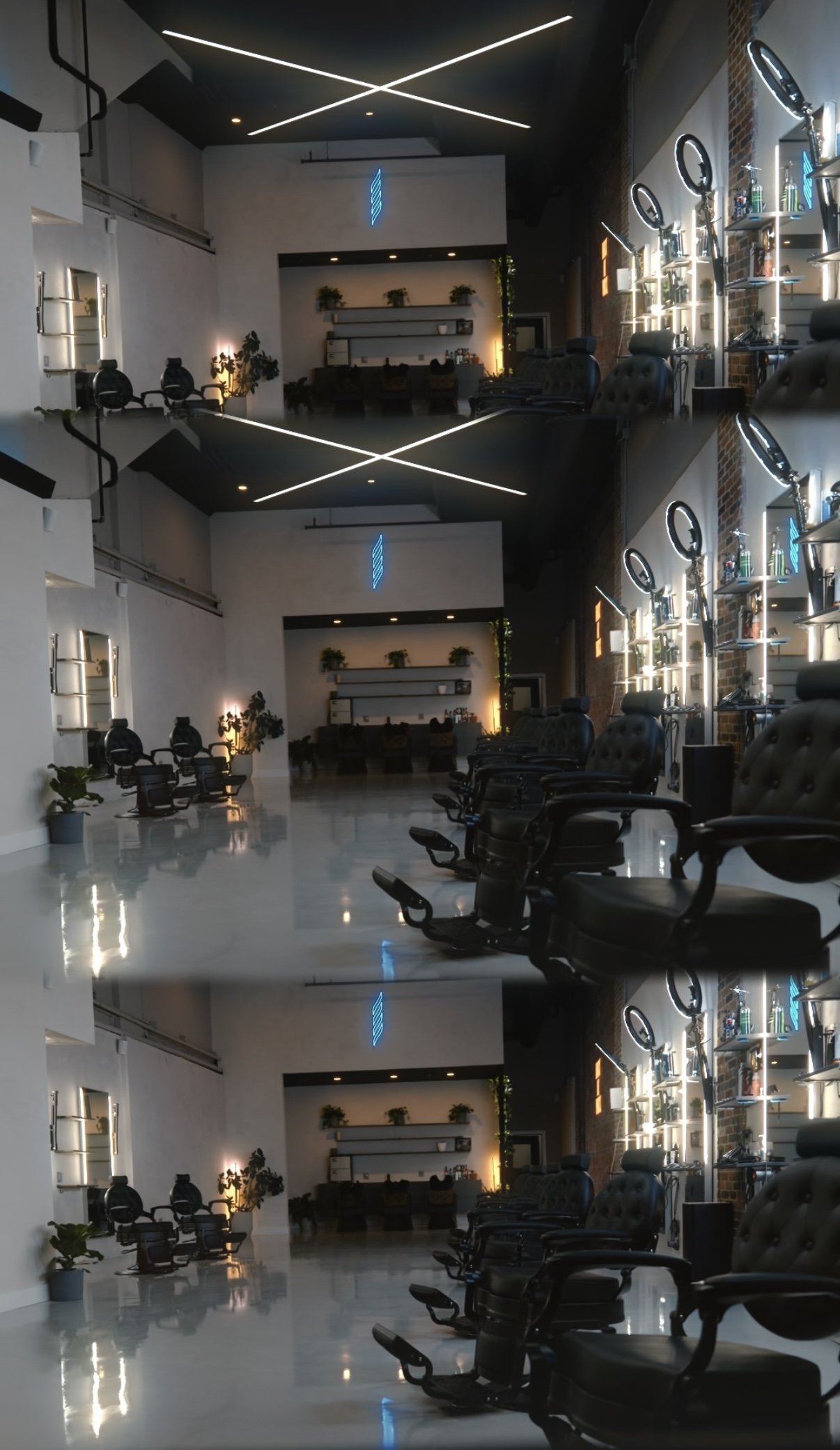 Interior of a modern hair salon with black leather barber chairs, illuminated ring lights, and shelves with hair products, reflected in a mirror.