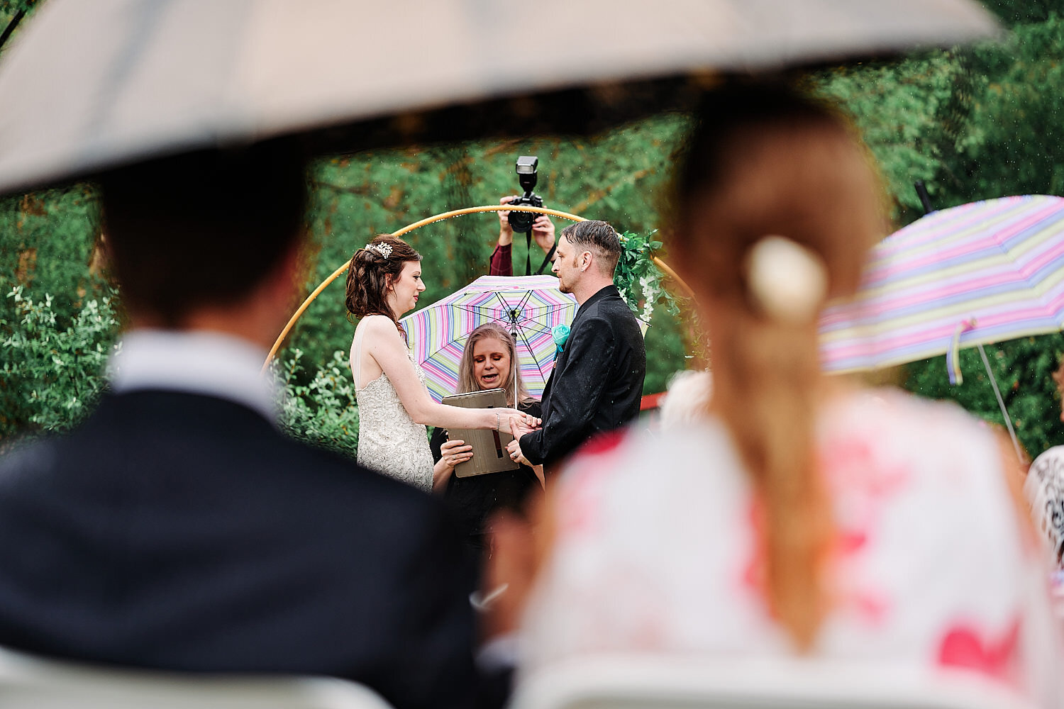  Alyssa Busching and George Goettel are getting married in their grandparents’ backyard under the pouring rain in the minds of the COVID-19 pandemic with only closest friends and family at the ceremony 