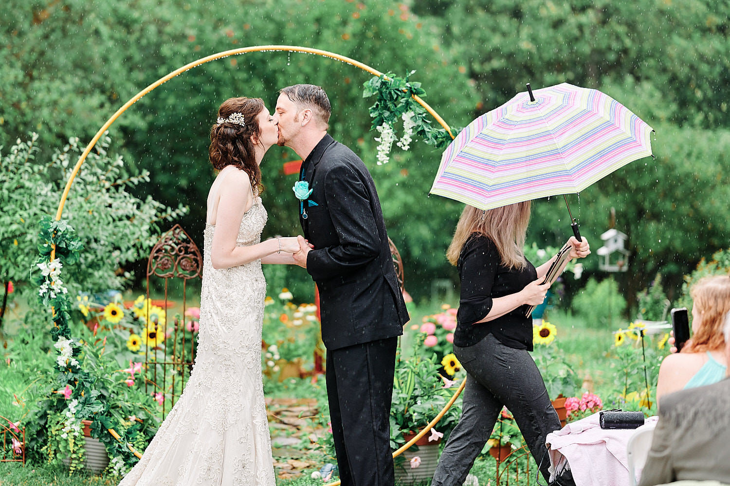  Alyssa Busching and George Goettel are getting married in their grandparents’ backyard under the pouring rain in the minds of the COVID-19 pandemic with only closest friends and family at the ceremony 