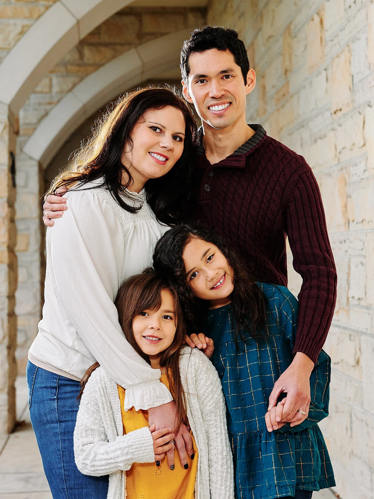  Sarah Evans and her husband Cliff and two young daughtersShannon and Sophia   are posing for Christmas card photos in Sewickley Pennsylvania in November 2020 on a rainy day. 