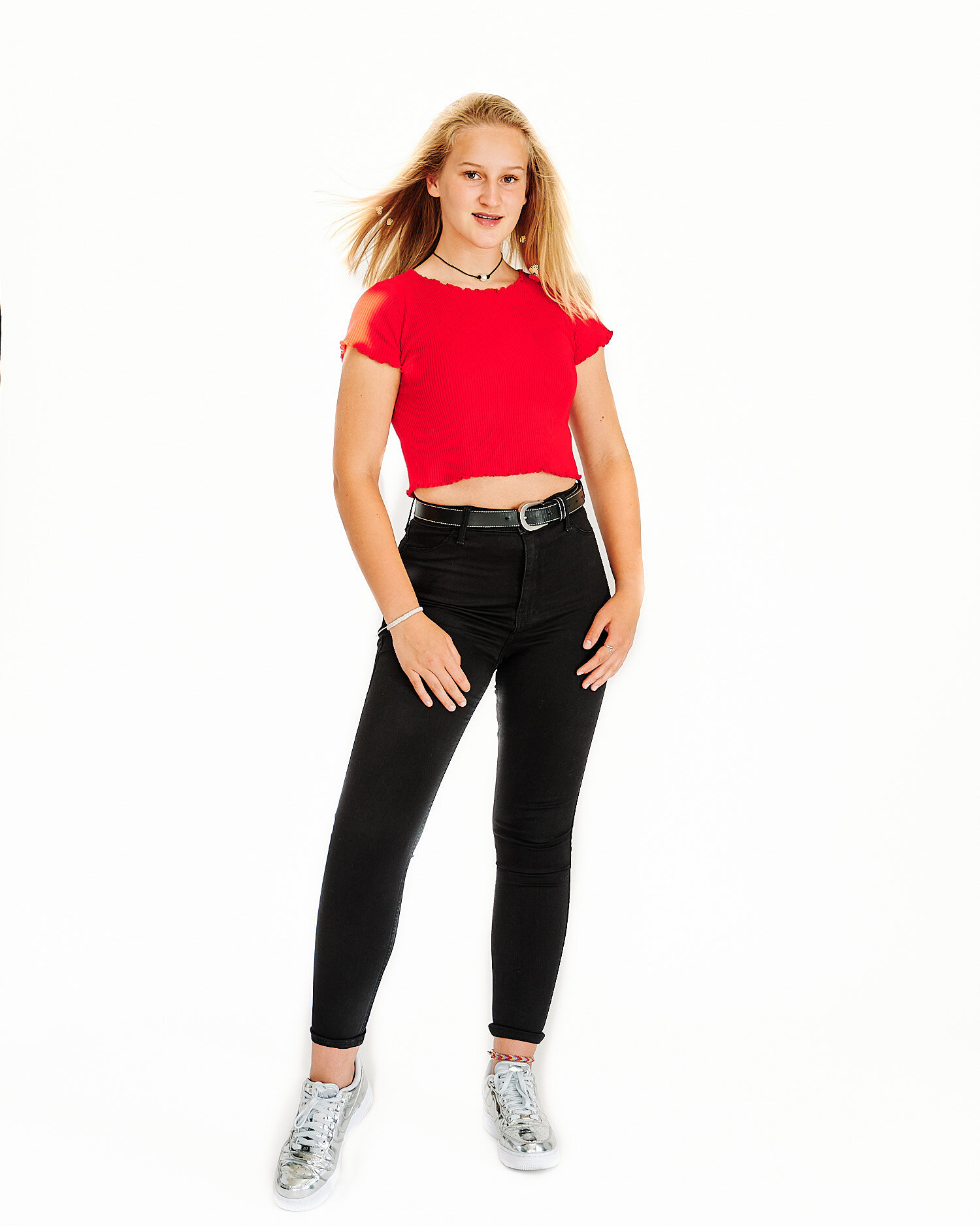  Alena Gurevich is posing for high key full-length portraits with Golden Retriever dog Joyka in a professional photo studio in Sewickley Pennsylvania near Pittsburgh in 2020. Wearing in red and black. 