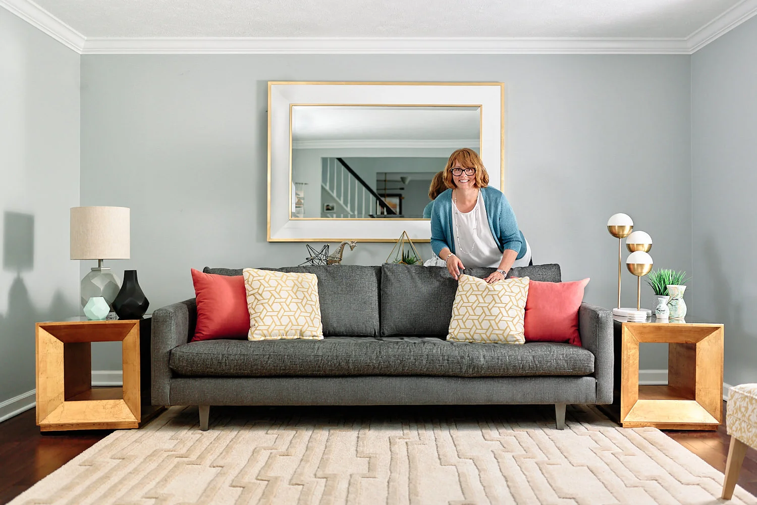  Juliane Mazzarella of Avenue Interiors (since 2016) is posing for her portraits in a sitting room that she had designed. She is also promoting one of the cushions that she’s going to sell soon. 
