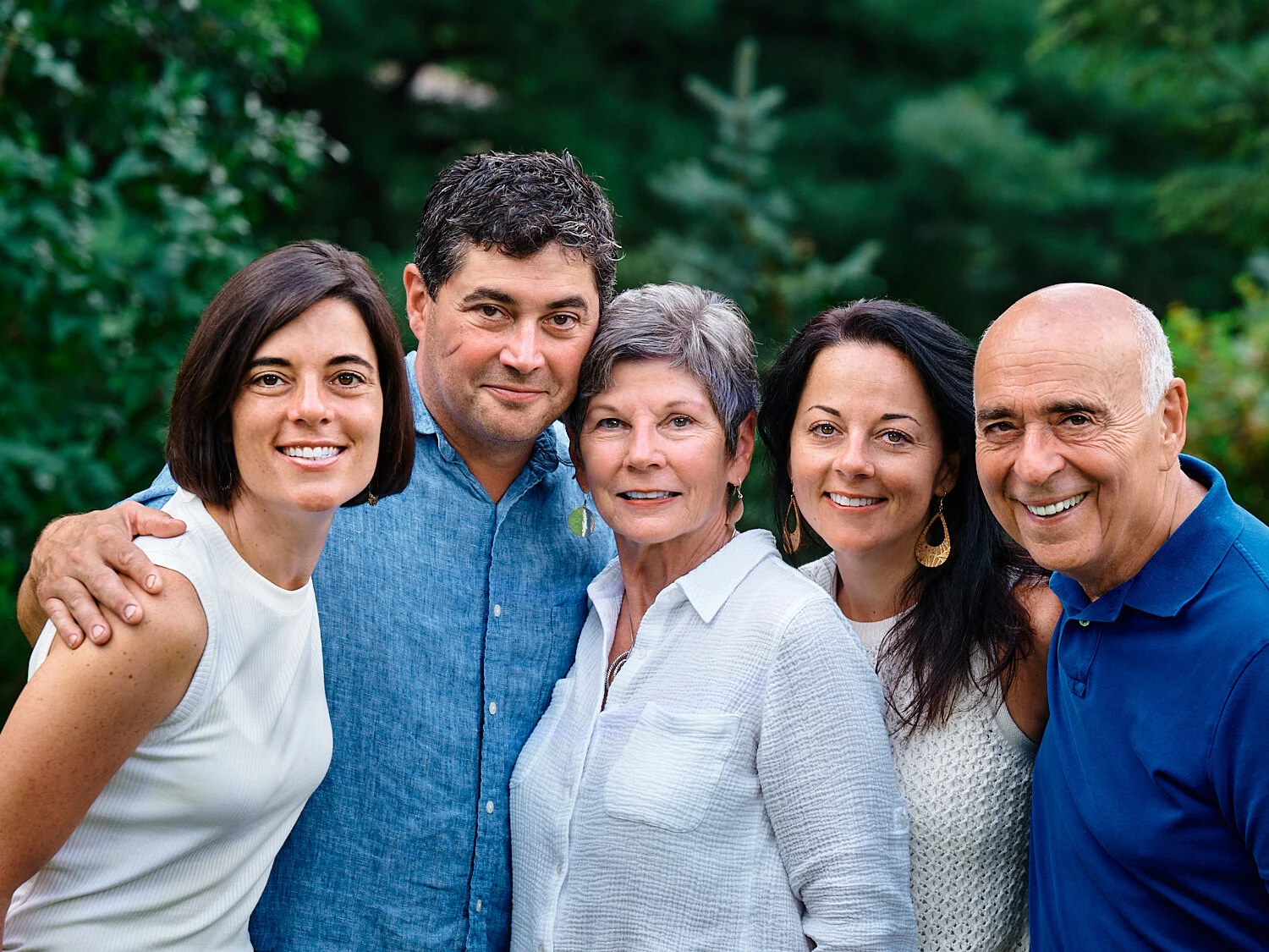  The extended Peluso family members are posing for a group photograph in their house in Sewickley, west of Pittsburgh, Pennsylvania. They are dressed in white and blue and look very handsome and happy. 