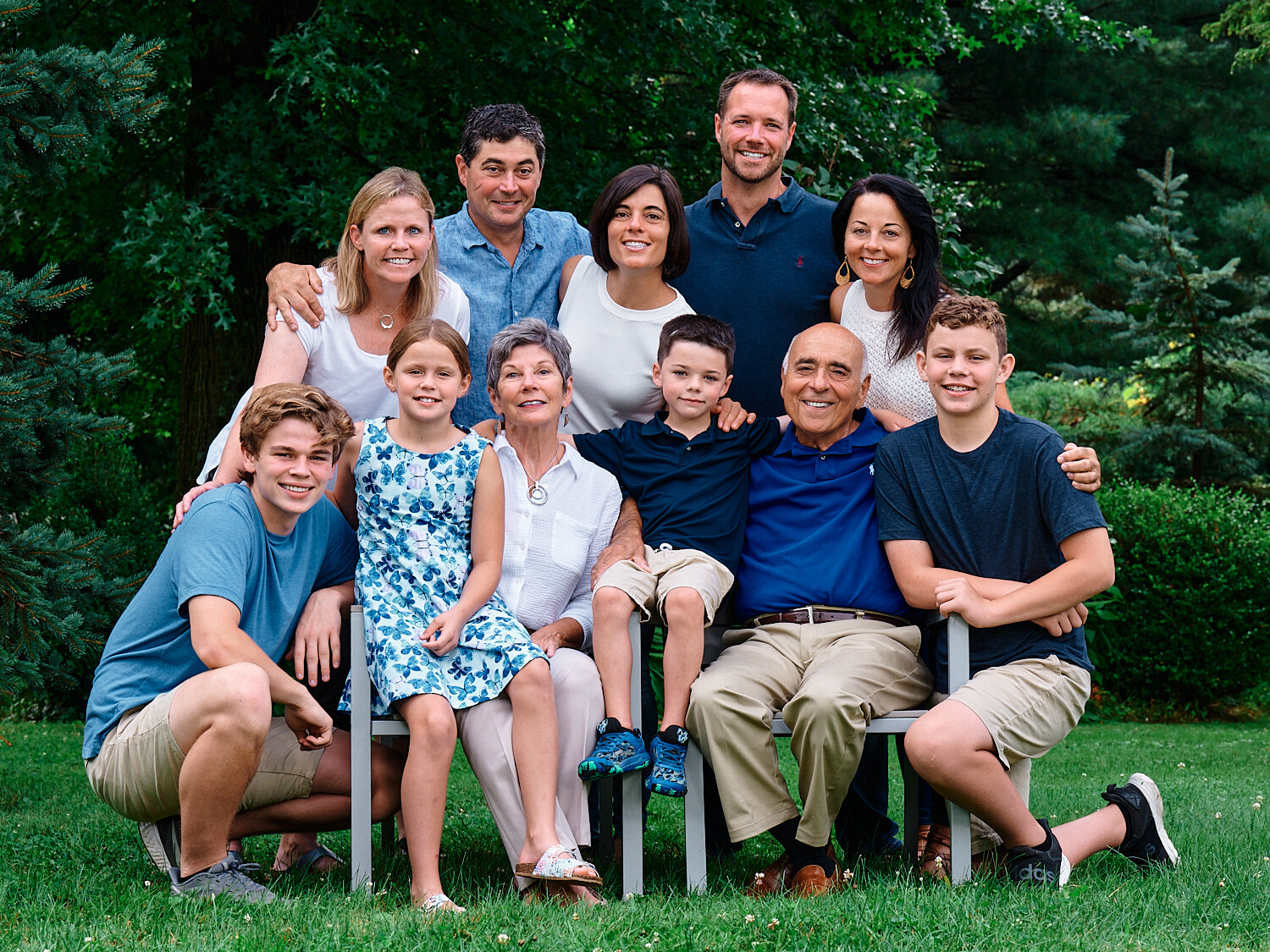  The extended Peluso family members are posing for a group photograph in their house in Sewickley, west of Pittsburgh, Pennsylvania. They are dressed in white and blue and look very handsome and happy. 