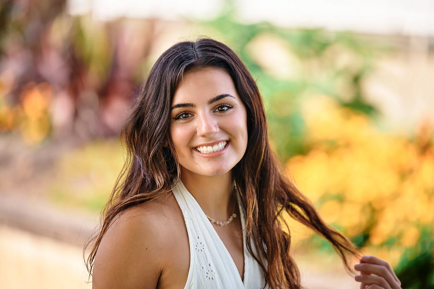  A High school senior Lily Mejia is posing for her yearbook portraits at Phipps Conservatory and Botanical Gardens and Schenley Park in Pittsburgh, Pennsylvania, USA. The girl looks beautiful and happy 