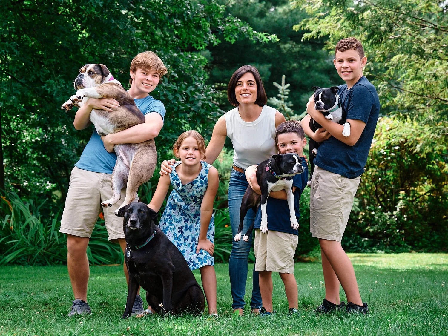  The extended Peluso family members are posing for a group photograph in their house in Sewickley, west of Pittsburgh, Pennsylvania. They are dressed in white and blue and look very handsome and happy. 
