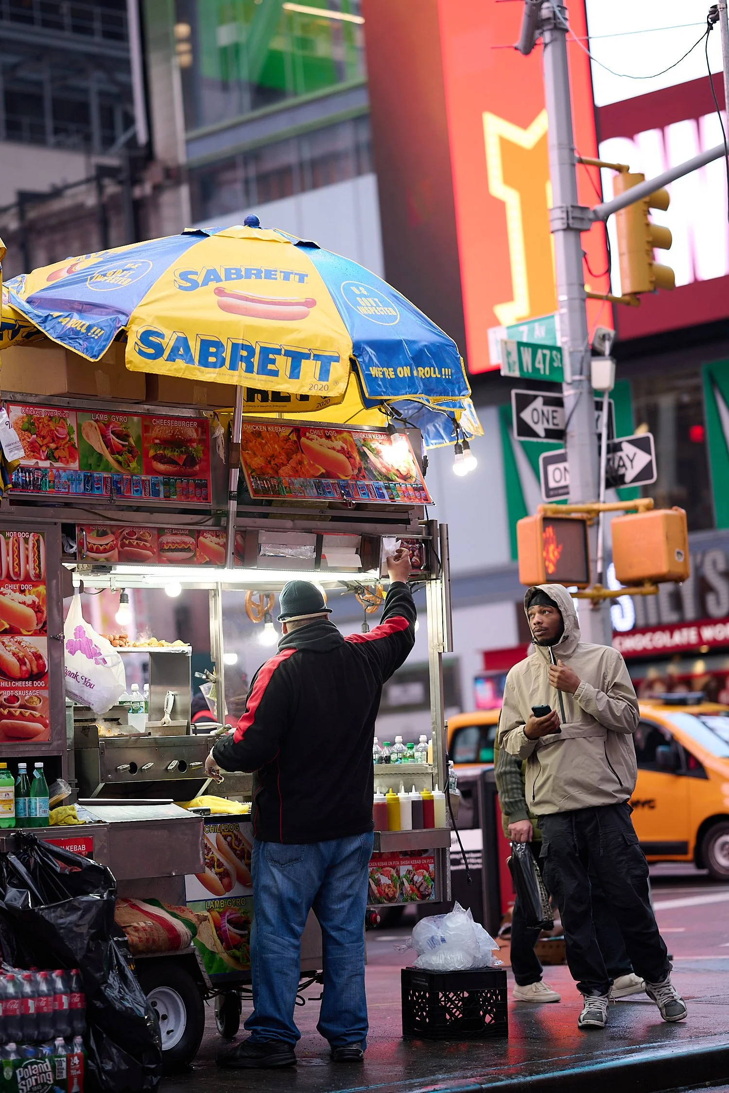 NEW YORK CITY, USA - DECEMBER 11TH 2021: Christmas mood at Times Square, Manhattan. It’s a foggy morning and the festive light, classic smoke and people passing by are reflected in the paddles.