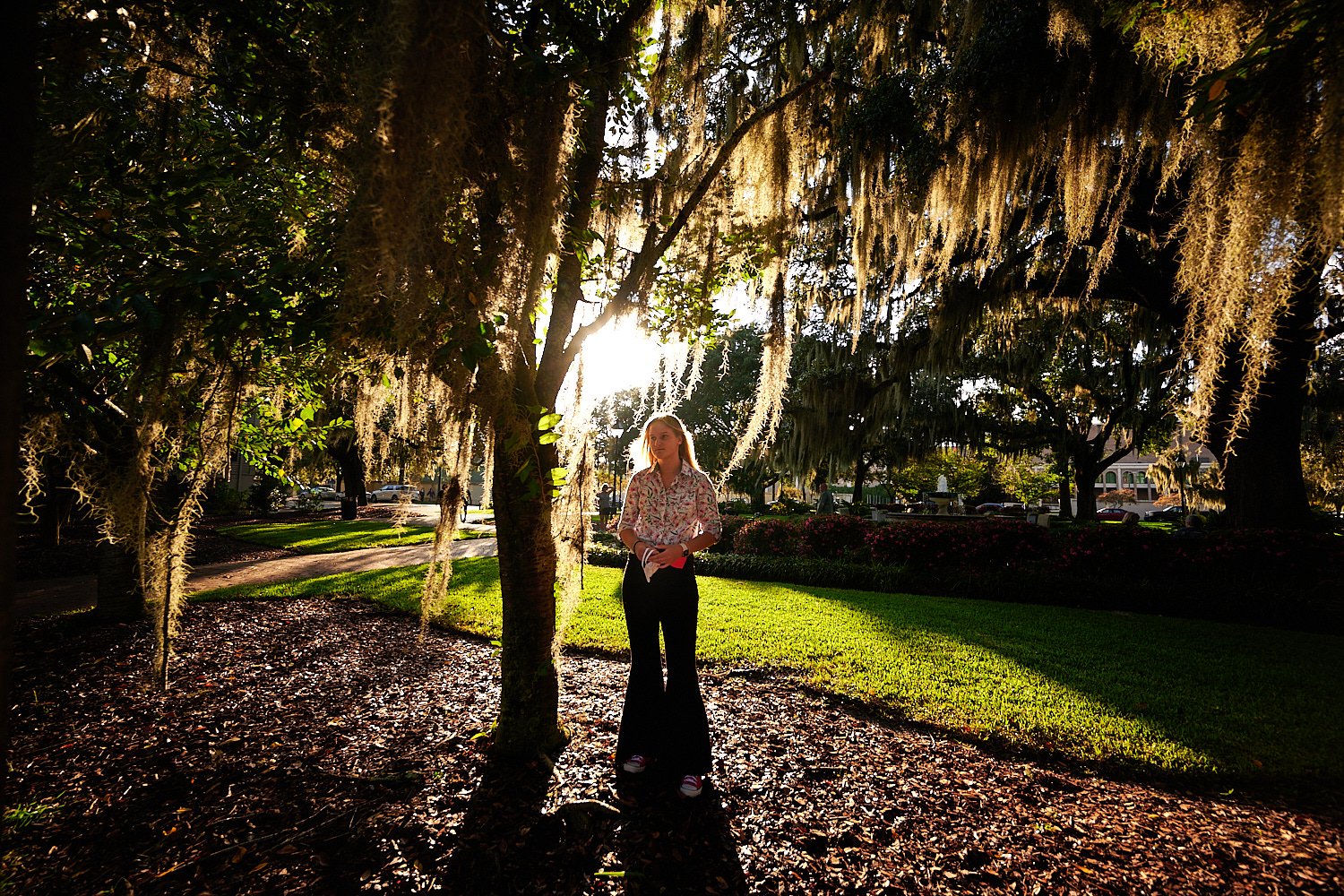  Savannah, Georgia, USA - OCTOBER 9TH 2021: a teenage girl is posing in the streets of Savannah on a warm autumn evening lit by the setting sun. The 16-year old had long blond hair and wore flare jeans 