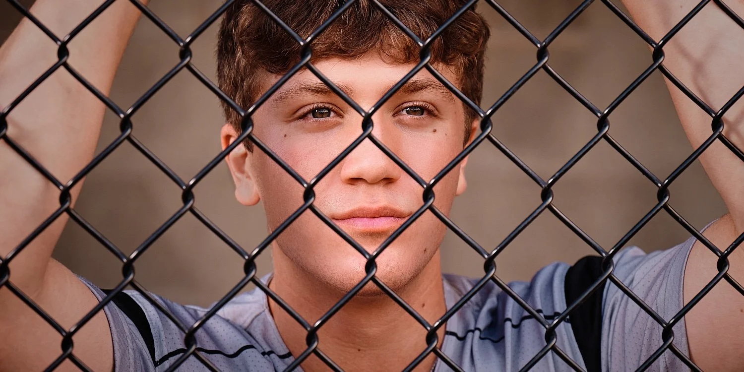  Colin Elias is posing for his high school senior portraits at Robin hill Park and at the baseball field in Moon park near Pittsburgh, PA. It’s still hot and sunny in September and feels like summer. 