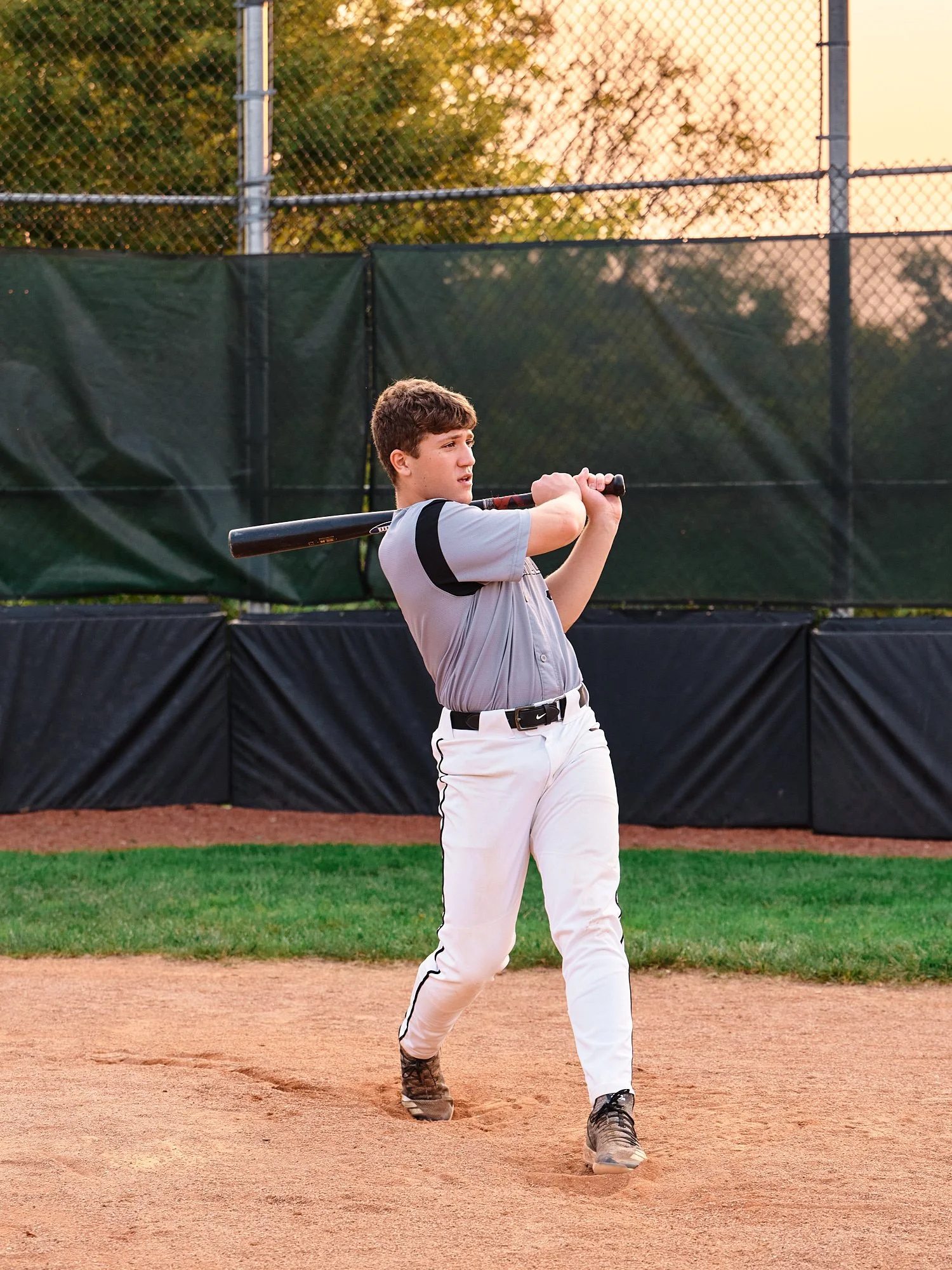  Colin Elias is posing for his high school senior portraits at Robin hill Park and at the baseball field in Moon park near Pittsburgh, PA. It’s still hot and sunny in September and feels like summer. 