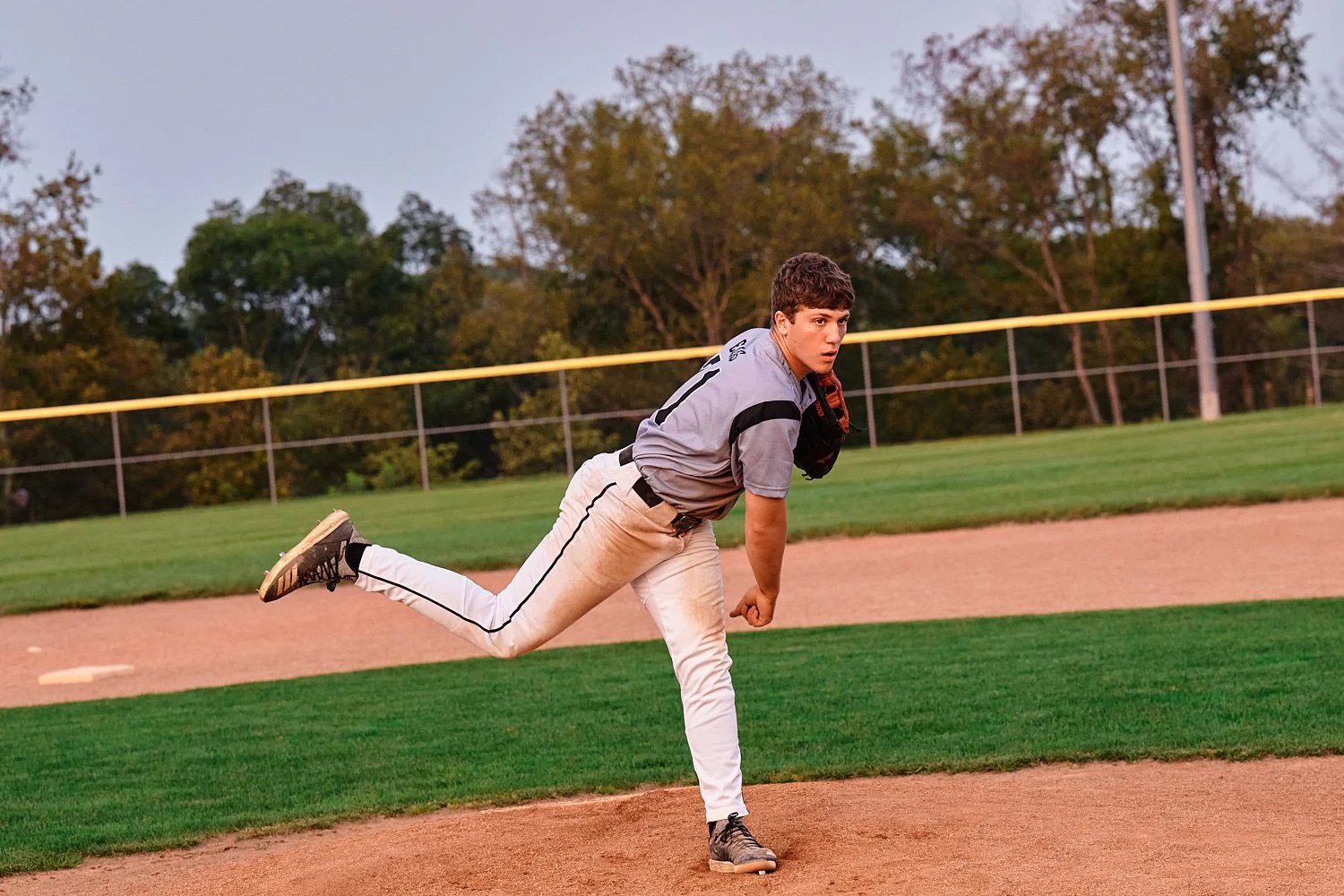  Colin Elias is posing for his high school senior portraits at Robin hill Park and at the baseball field in Moon park near Pittsburgh, PA. It’s still hot and sunny in September and feels like summer. 