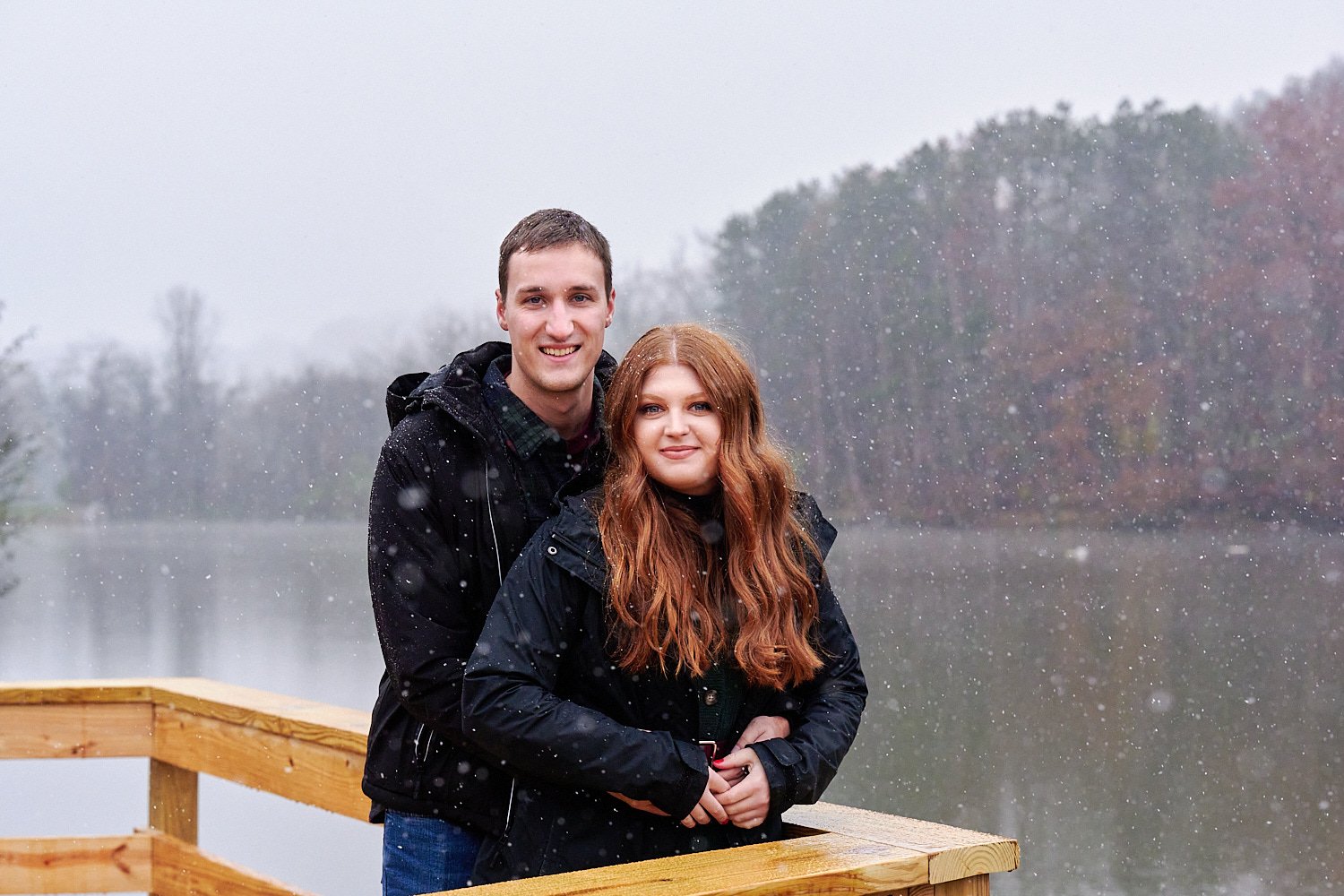  Victoria Detweiler is posing with her new husband on Marshall Island in North Park, Allegheny County near Pittsburgh, Pennsylvania. It’s very cold and it’s snowing. The trees around have few colors. 