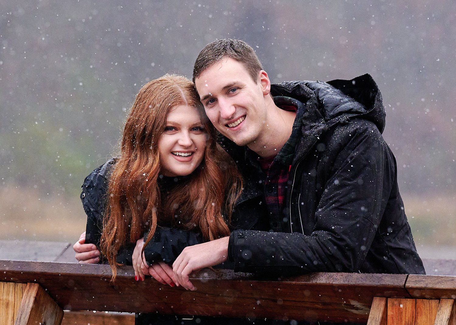  Victoria Detweiler is posing with her new husband on Marshall Island in North Park, Allegheny County near Pittsburgh, Pennsylvania. It’s very cold and it’s snowing. The trees around have few colors. 