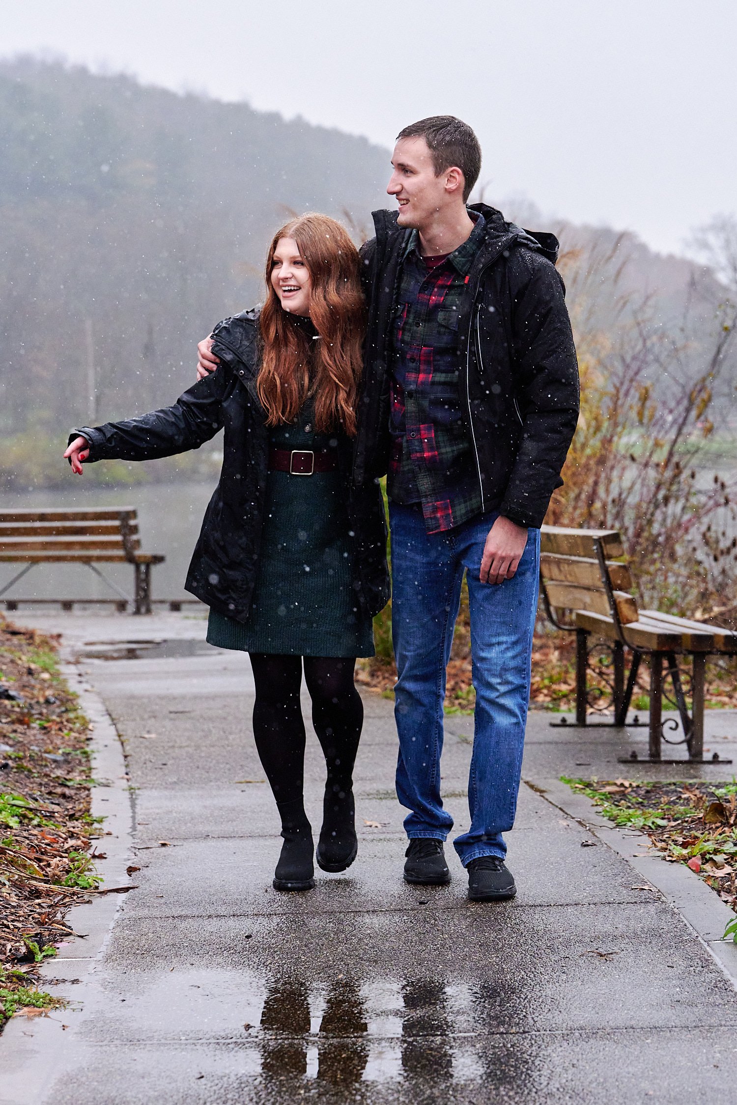  Victoria Detweiler is posing with her new husband on Marshall Island in North Park, Allegheny County near Pittsburgh, Pennsylvania. It’s very cold and it’s snowing. The trees around have few colors. 