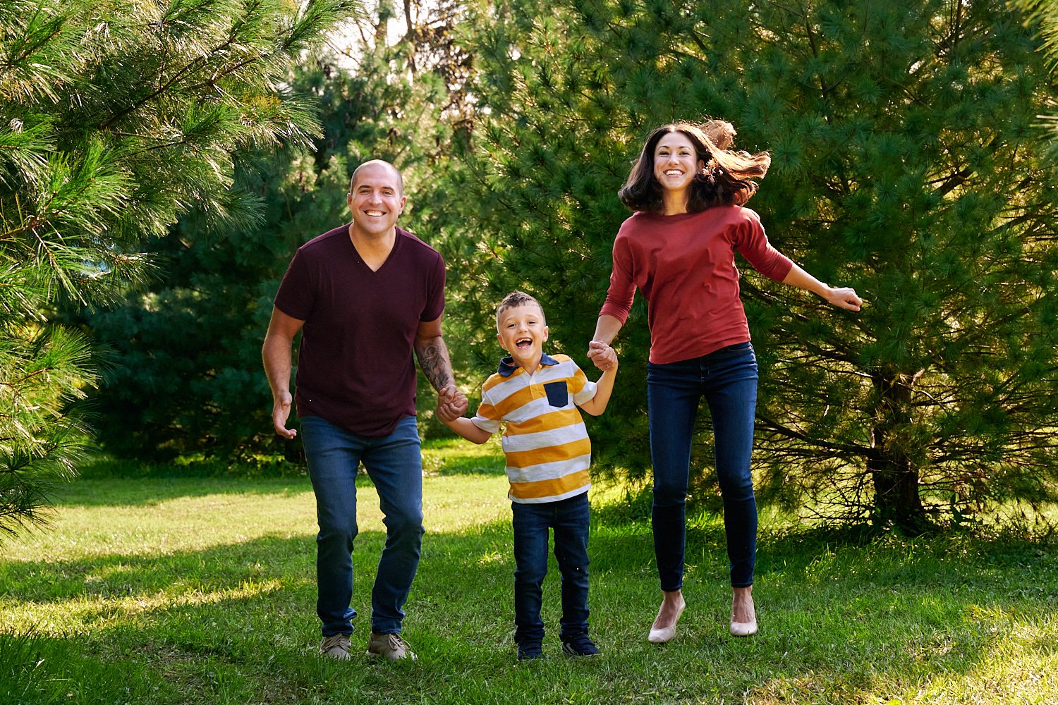  Erin Greiner is posing for formal and candid family photos with her husband and six-year-old son. The Cranberry community park has a pond and pine trees for Christmas-style and summer themed portraits 