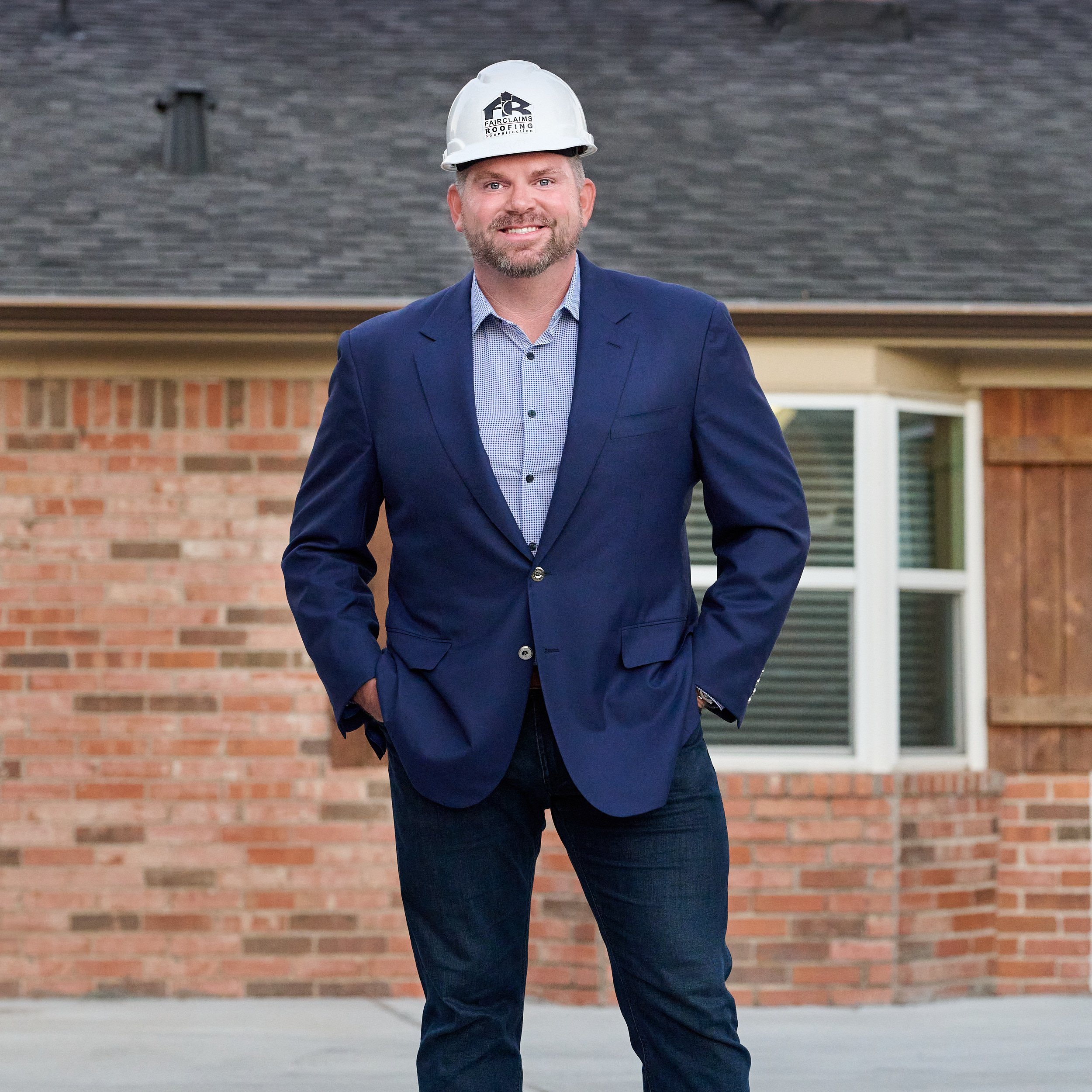  SPRING, TEXAS - SEPTEMBER 30th  2022: Justin O'Neal of Fairclaims Roofing & Construction is posing in a suit and helmet for environmental portraits at his office to promote his business at Living Magazine 