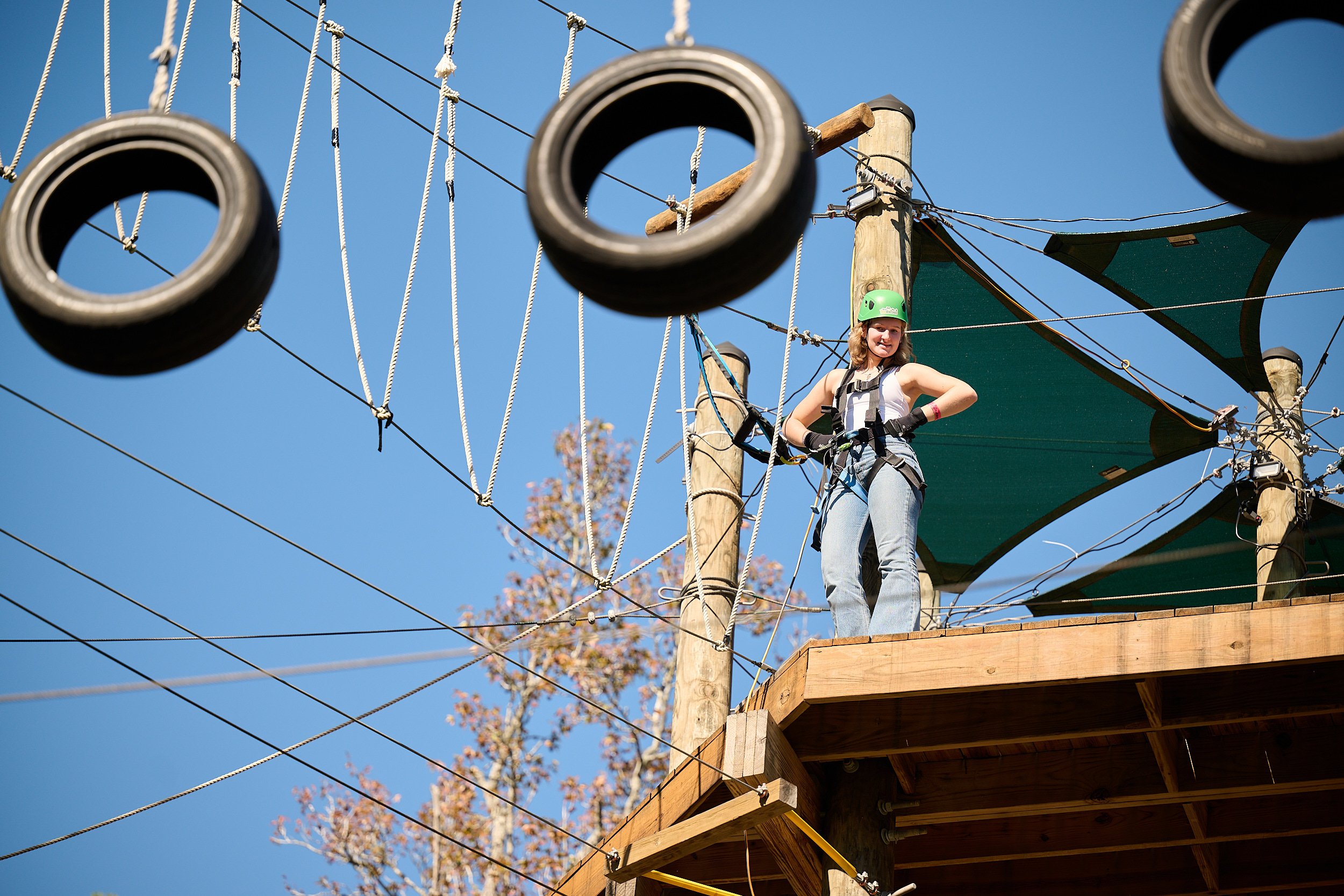  HOUSTON, TEXAS - NOVEMBER 2022: a group of excited teenagers are celebrating their best friend’s 17th birthday at Texas TreeVentures traversing the physically challenging course high above the ground 