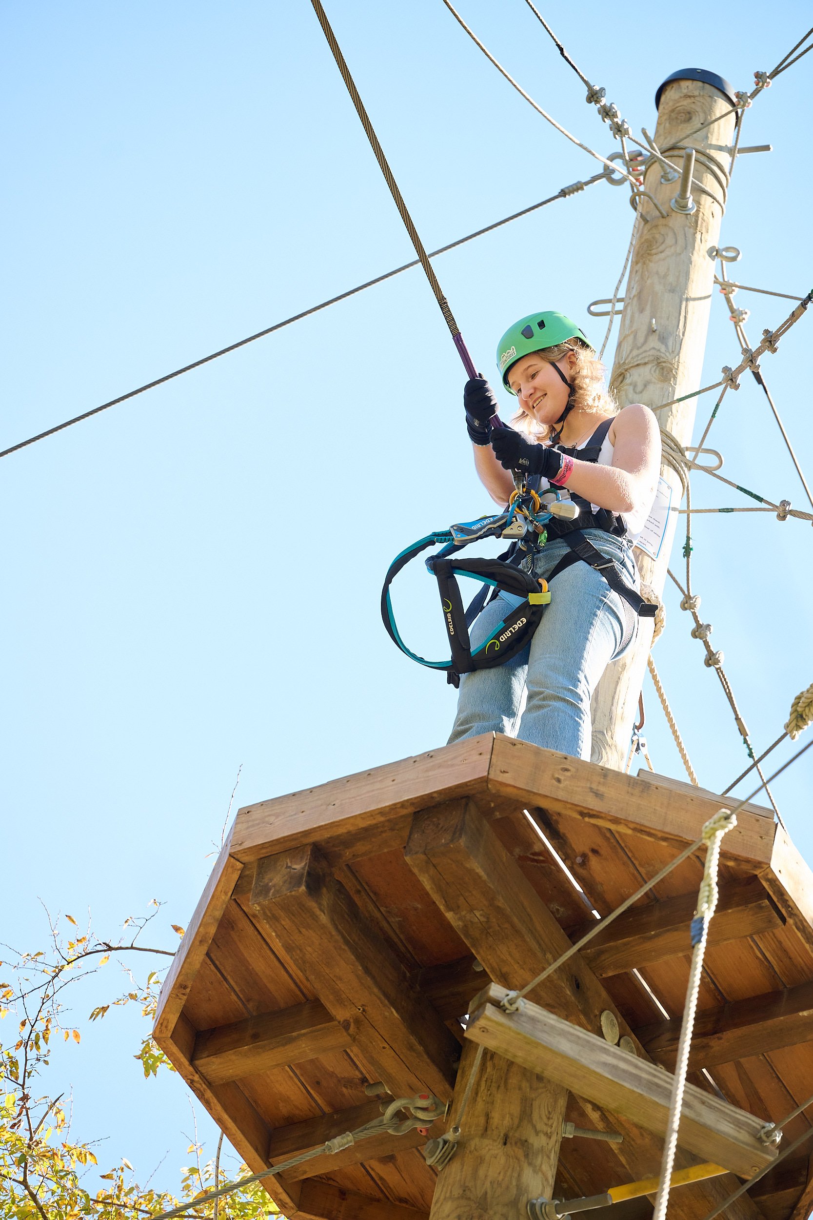  HOUSTON, TEXAS - NOVEMBER 2022: a group of excited teenagers are celebrating their best friend’s 17th birthday at Texas TreeVentures traversing the physically challenging course high above the ground 
