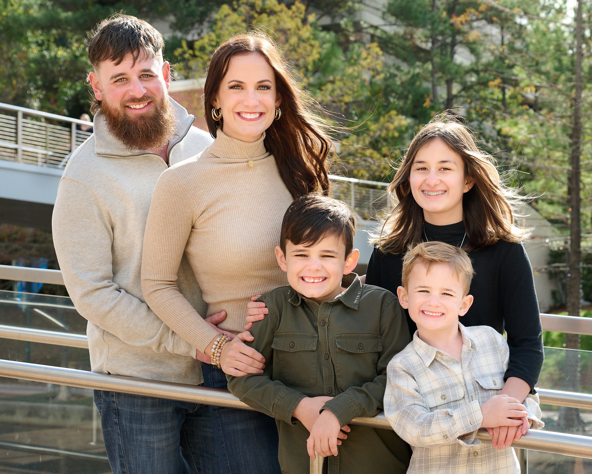  THE WOODLANDS, TEXAS - DECEMBER 2022: Katie Sikorski and her 12 family members are posing for annual Christmas cards on the embankment of The Woodlands Waterway. Fall foliage colors are still there. 