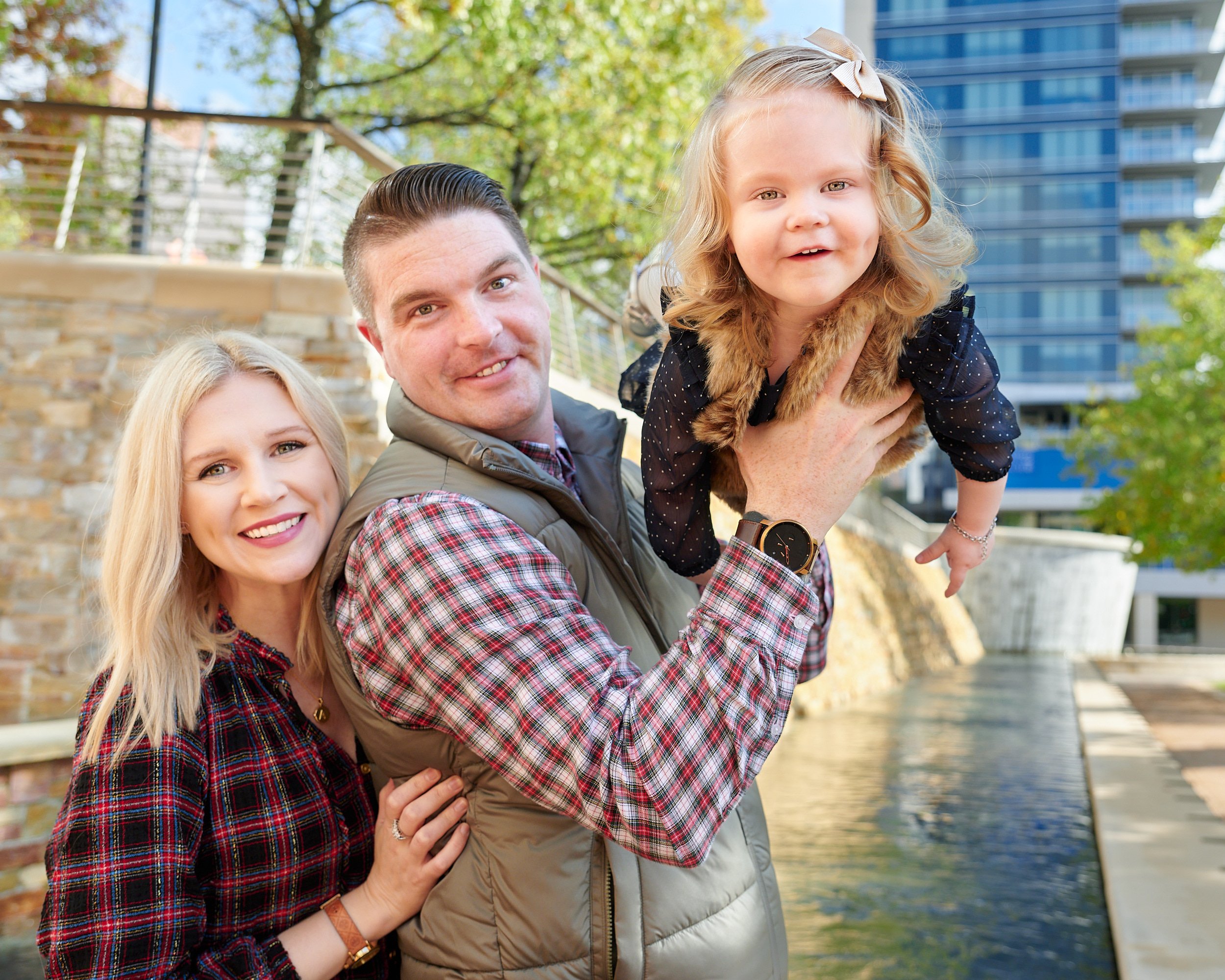  HOUSTON, TEXAS - DECEMBER 2022: atmospheric environmental photos for Shana Grant, her 2-year-old daughter and husband with the stunning architecture on The Woodlands Waterway Square in the background 