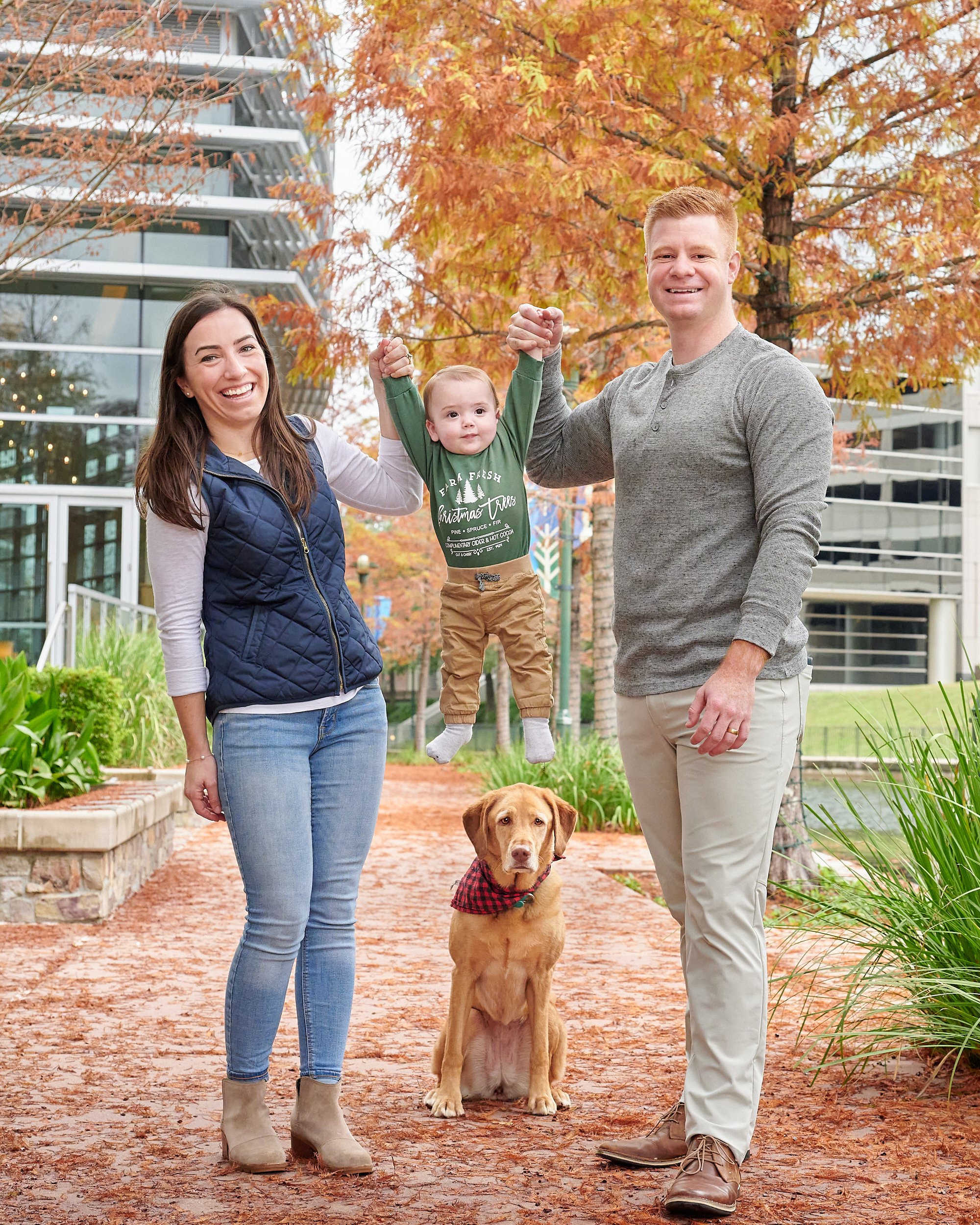  HOUSTON, TEXAS - DECEMBER 2022: atmospheric environmental photos for Katie L Kerr, her 1-year-old son, loving husband and dog with the stunning architecture on The Woodlands Waterway in the background 