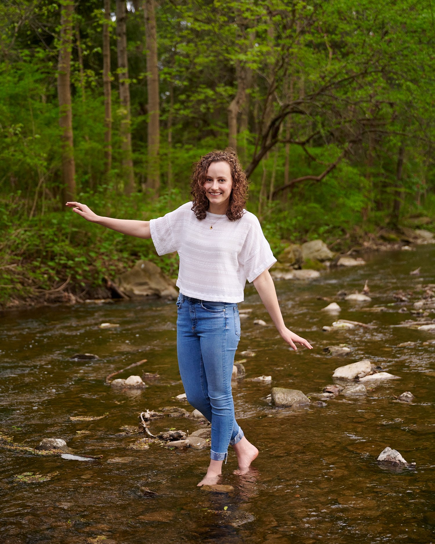  Rebecca Glass is posing for her high school senior portraits with beautiful spring flowers and water as she is an avid swimmer. Class of 2022, Sewickley Academy, Pittsburgh, Pennsylvania, USA. 