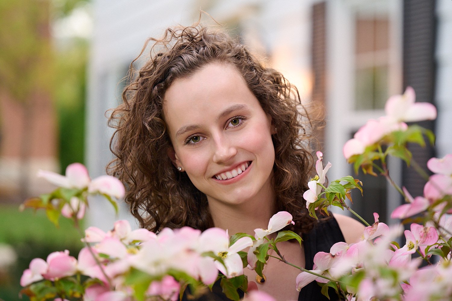  Rebecca Glass is posing for her high school senior portraits with beautiful spring flowers and water as she is an avid swimmer. Class of 2022, Sewickley Academy, Pittsburgh, Pennsylvania, USA. 