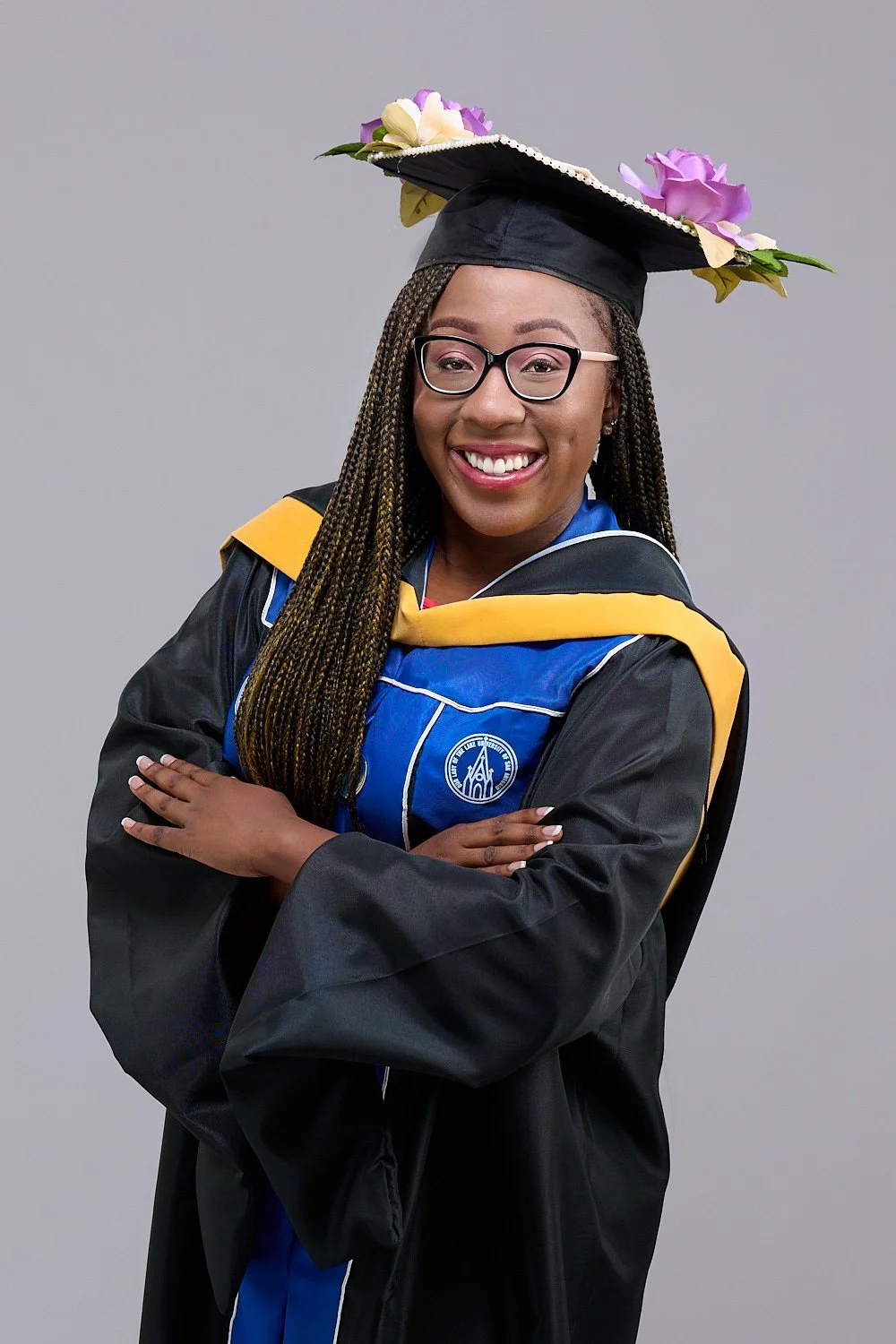  THE WOODLANDS, TEXAS - June 23rd 2023: Our Lady of the Lake University of San Antonio graduate Peyton Osuobeni is posing for her graduation portraits in black and blue cap and gown outfit. 