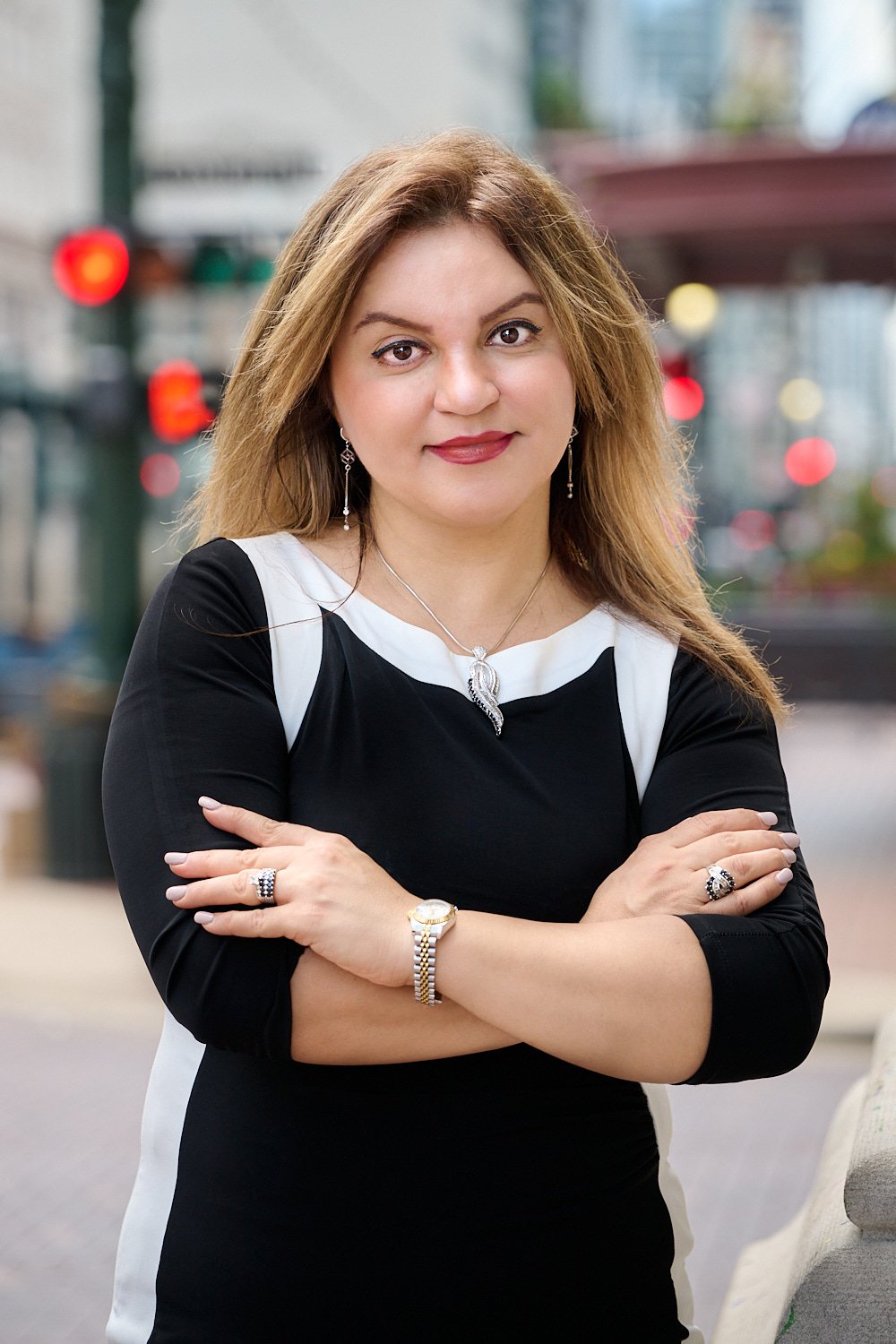  HOUSTON, TEXAS - AUGUST 27TH 2022: Rezvan Azimi is posing for her business headshots and marketing portraits for her real estate portfolio and social media feed. She looks professional in black dress 