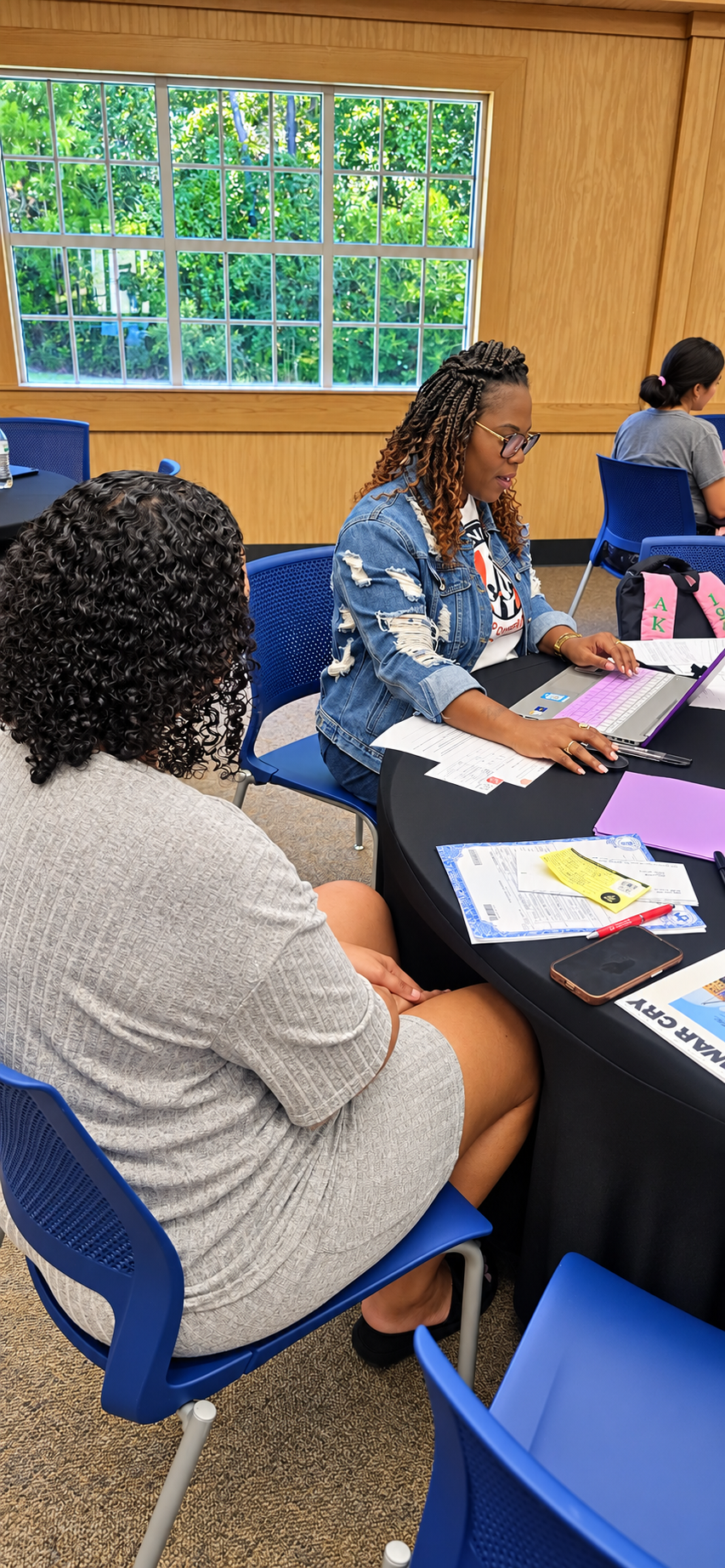 Dr. Katrina Haynes helping a parent register for Angel Tree program.