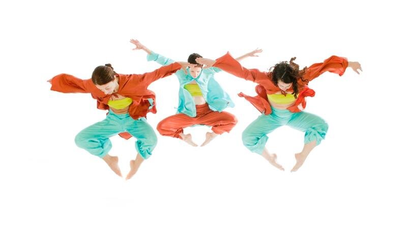 Three Dancers Jumping Straight Up Legs Bent